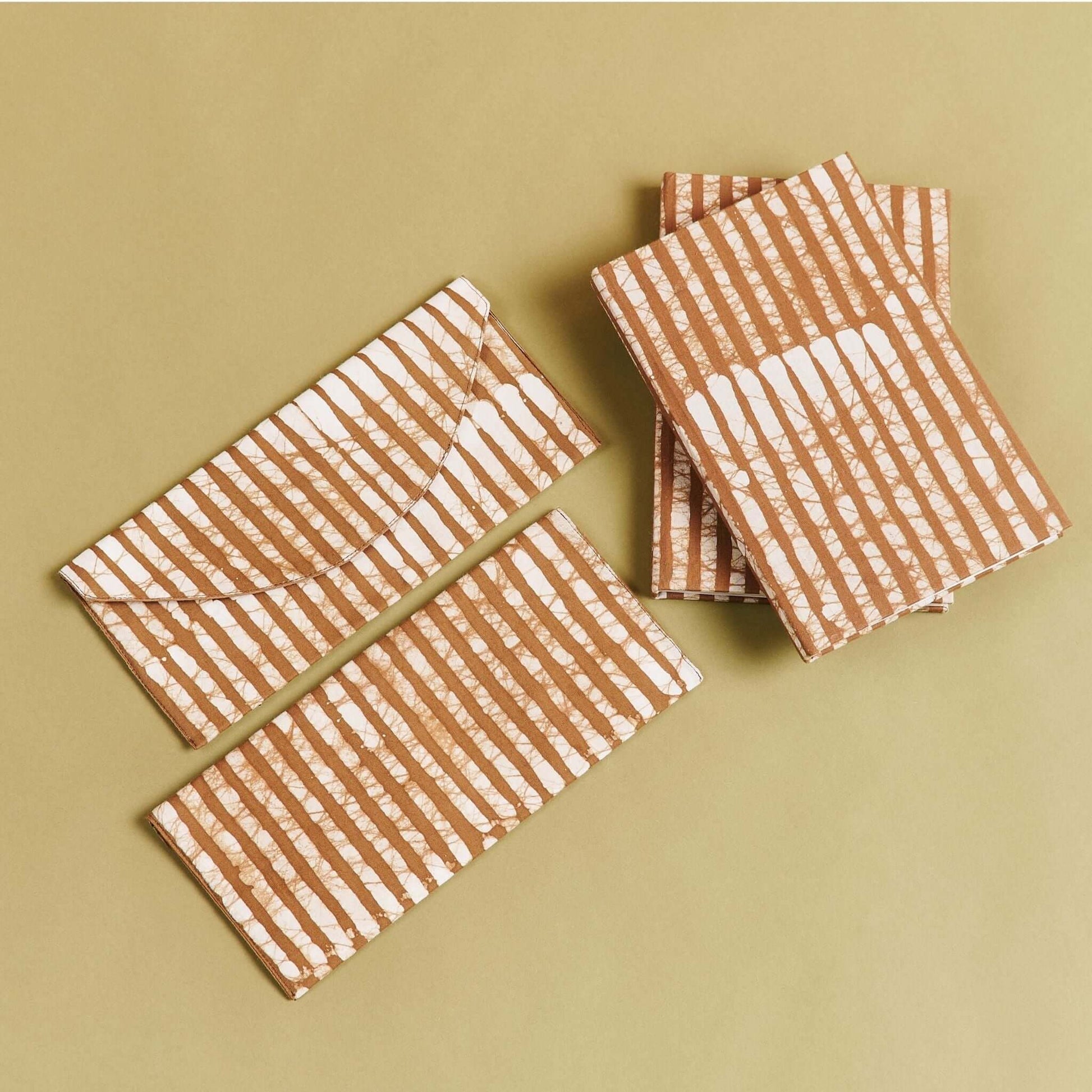 Oak Brown Stripes Cotton Wax Block Printed Envelope Pouch on a beige background.