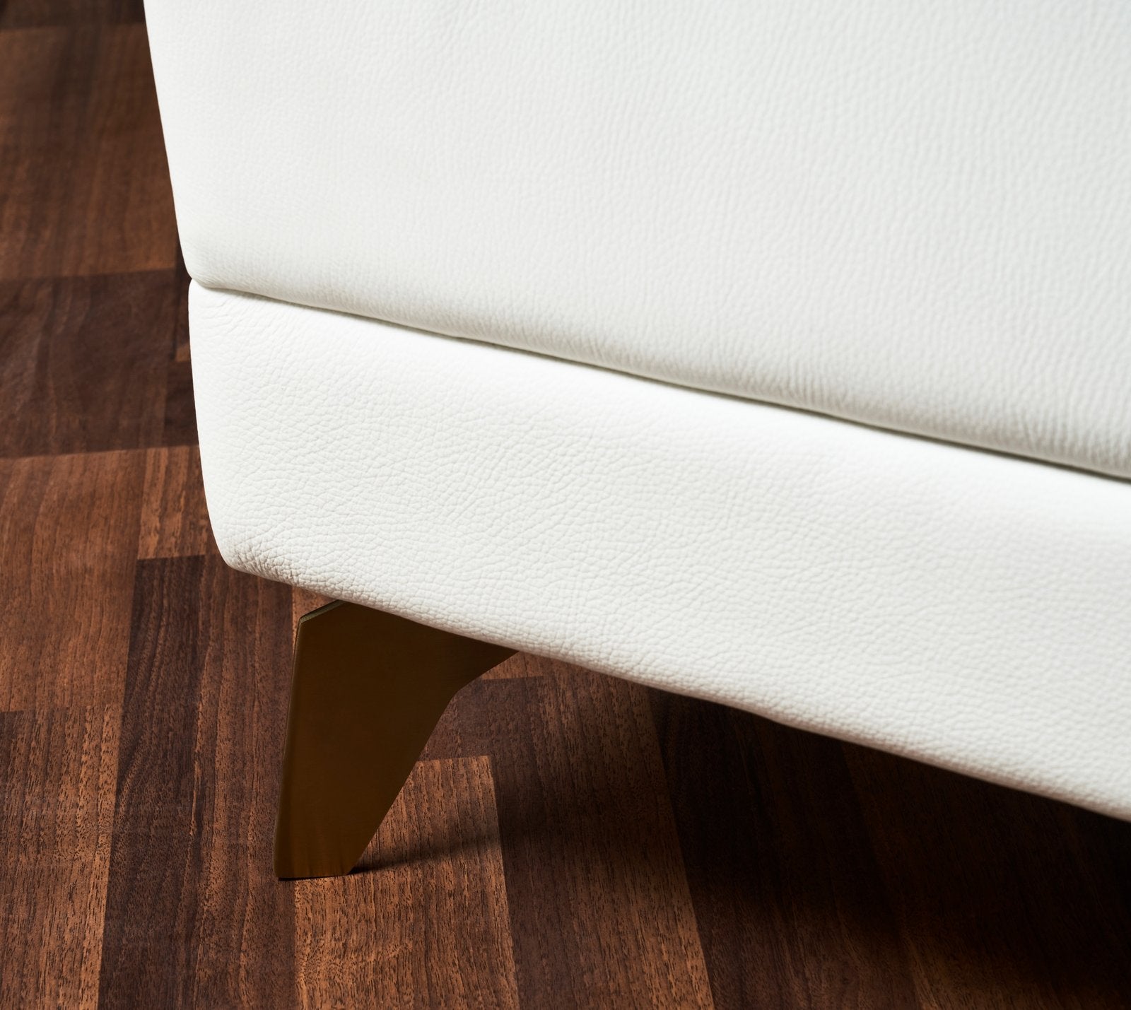 FN-5201-601618_7|Detailed view of the white genuine leather ottoman's textured upholstery and modern gold-finished conical leg design.