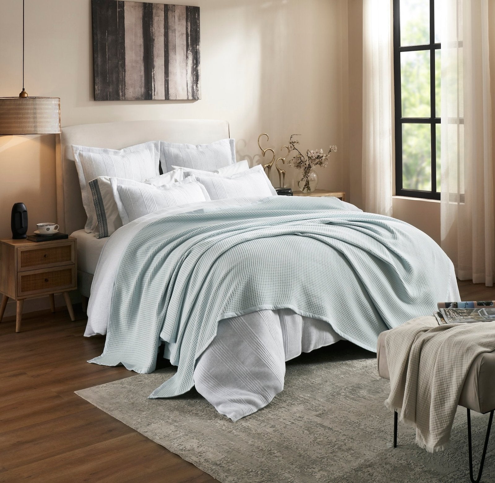 BL-857-9496_2|Light blue waffle knit blanket casually draped on a luxurious bed, offering soft, inviting comfort. (110)