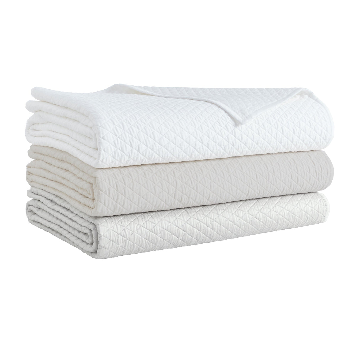 CL-265-11096_8|Stack of three diamond quilted coverlets: crisp white, soft ivory, and light gray. Luxurious bedding for a serene bedroom.