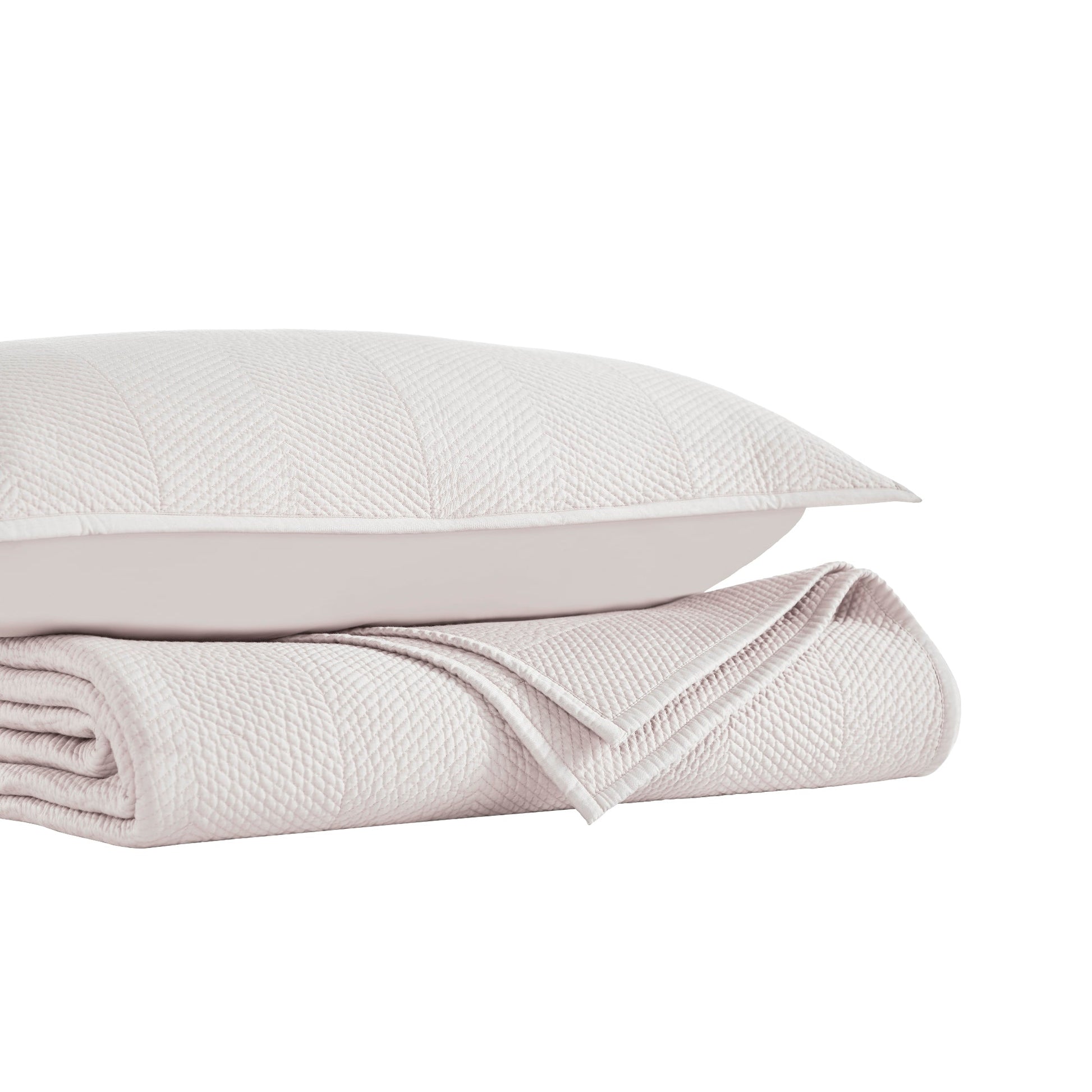 CL-171-11096-LOT1A_9|Stacked light beige herringbone quilted coverlet and pillow, ideal for adding elegant texture to any bed.