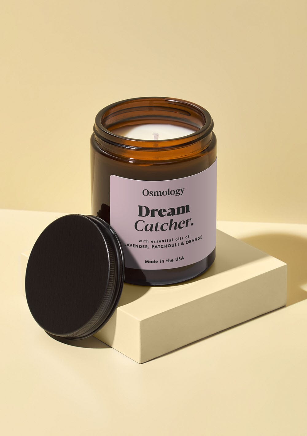 Osmology Dream Catcher jar candle with black lid on white background 