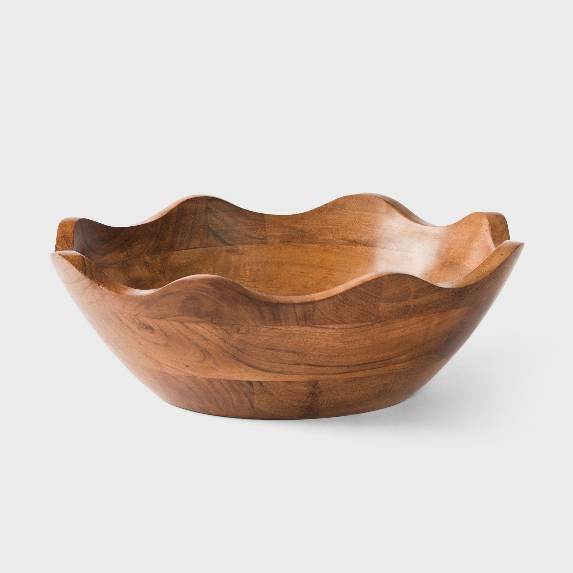 Handcrafted scalloped acacia wood bowl with a natural wavy edge for modern house decor