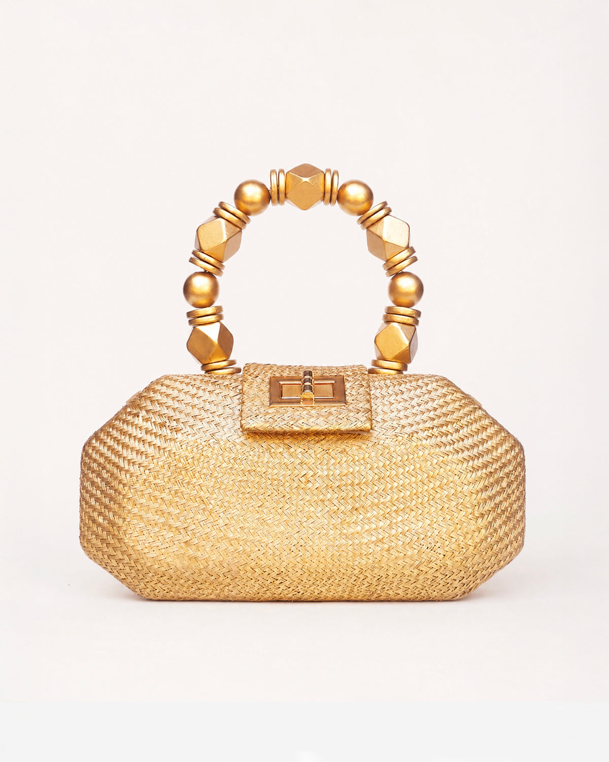 The Melia gold woven straw clutch bag with gold beaded top handle, front view