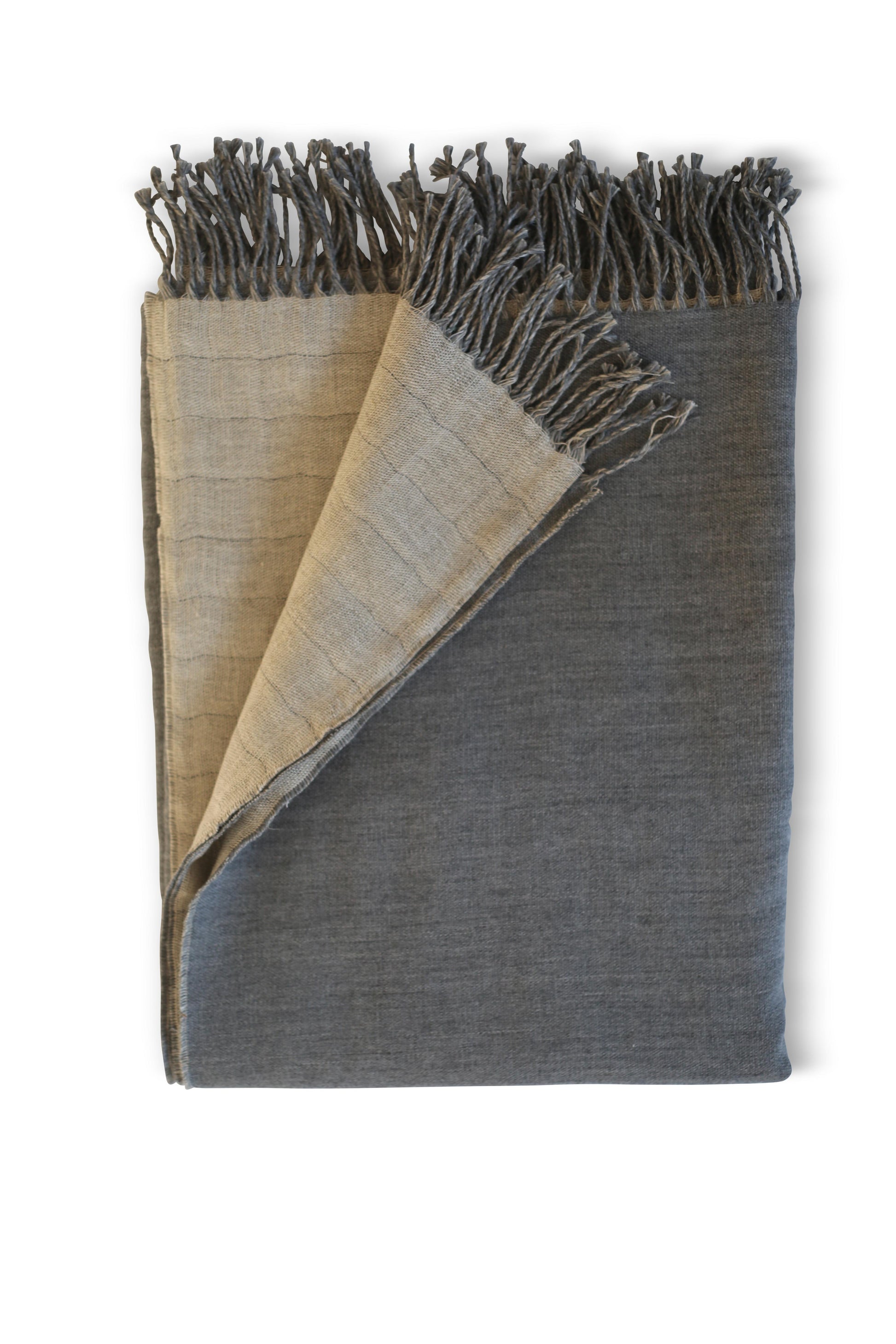 Indulge in opulence with this Evangeline Linens oversized throw blanket. Made from luxurious linen and merino wool, it boasts fringes and a reversible design. Pure elegance.