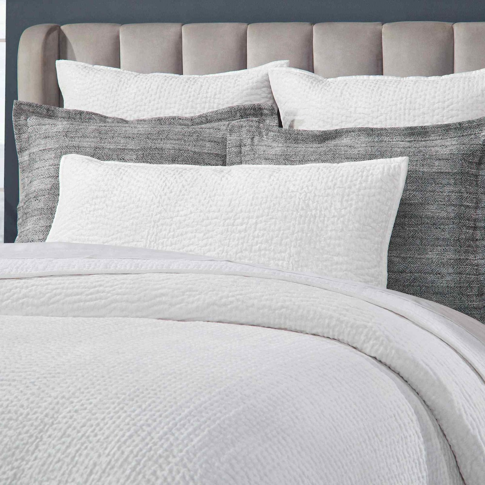 CL-182-9496-LOT1_4|Luxurious white textured waffle weave coverlet set with plush grey pillows, perfect for a modern bedroom aesthetic.