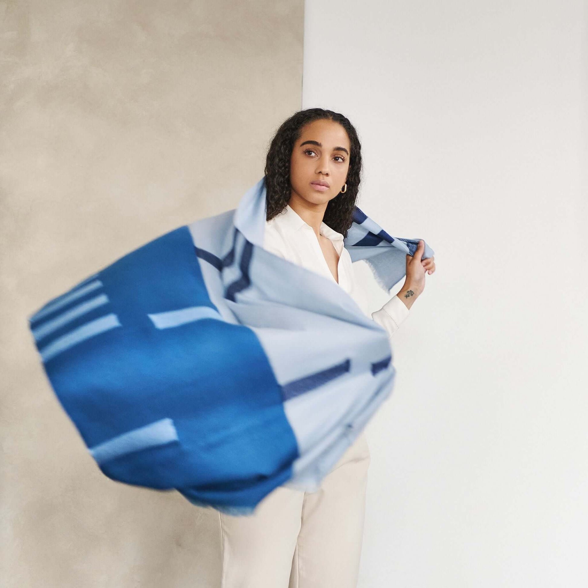 Harbor Blue Silk Merino Hand Woven Hand Embroidered Modern Artisanal Scarf worn by a model in motion.