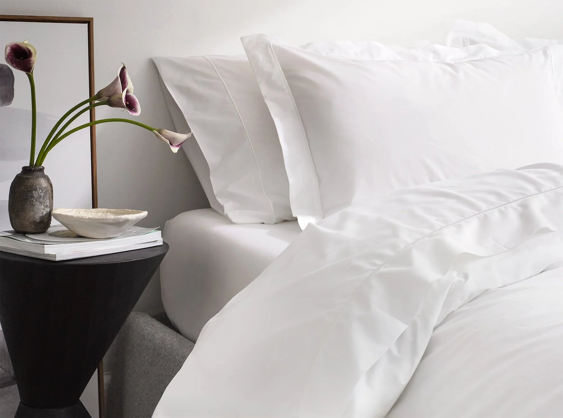 White organic cotton percale sheets on the bed with embroidered pillowcases - cool, crisp bedding