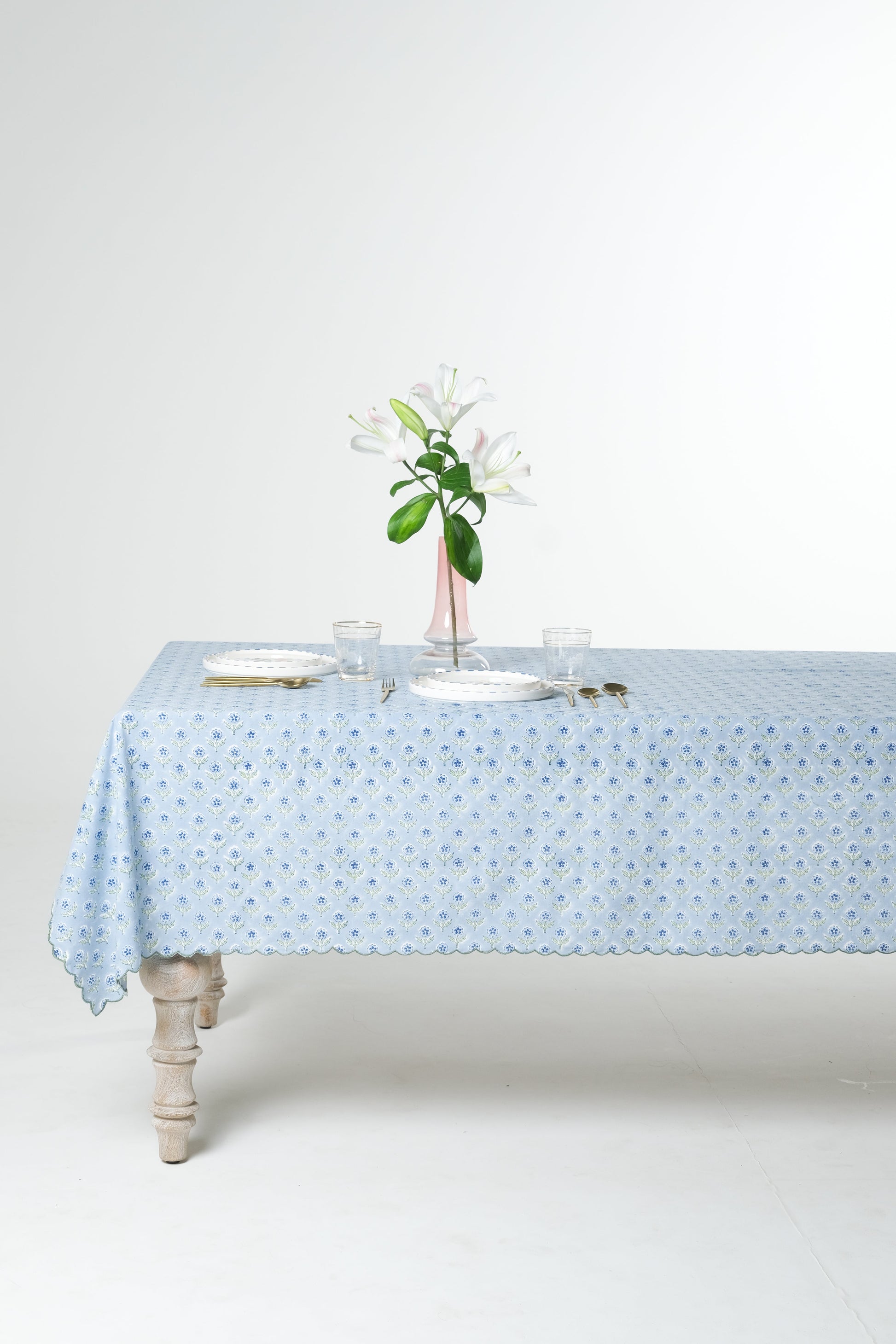 Inner Child blue scallop-edged embroidered blockprint tablecloth covering rectangular table