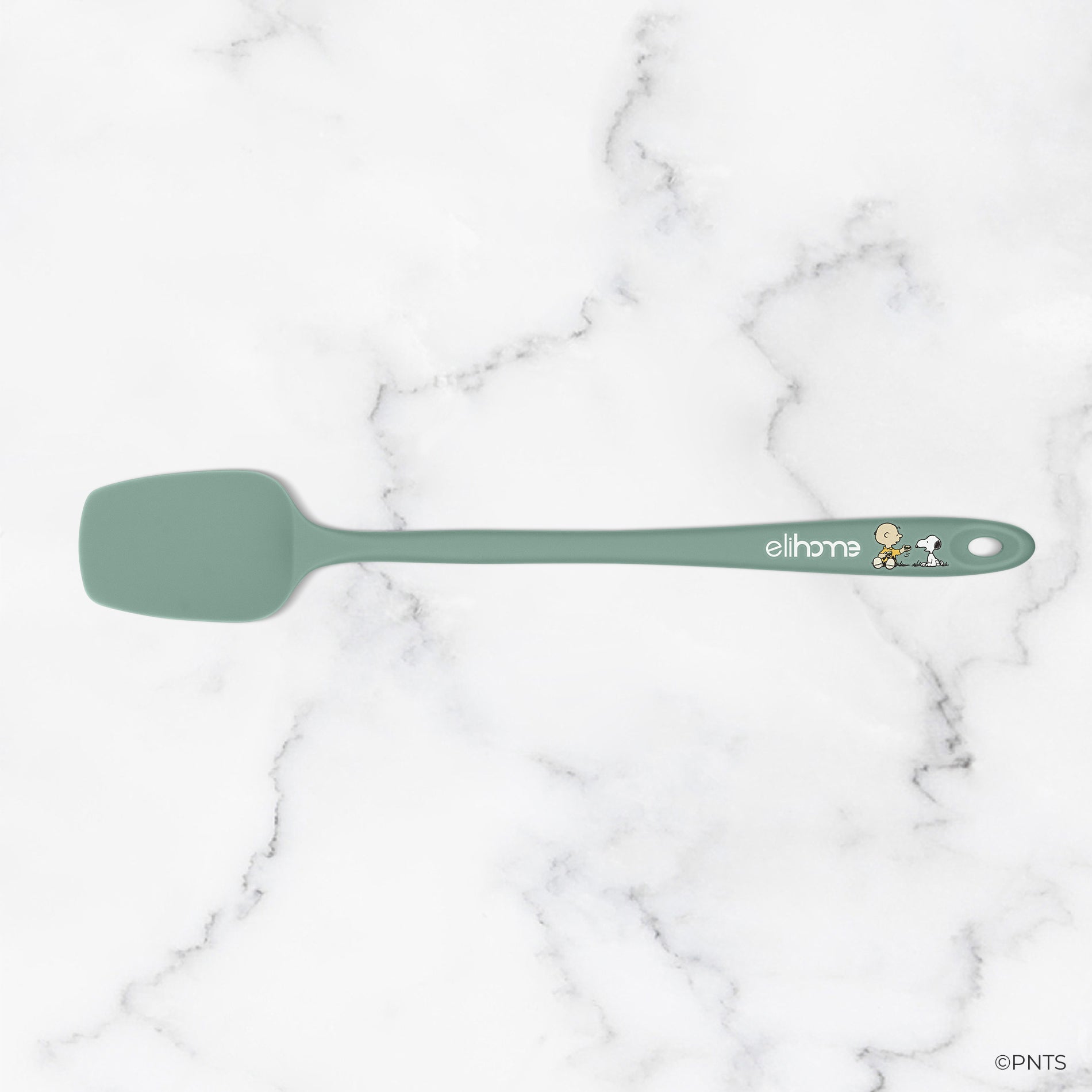 Green spatula on a marble background