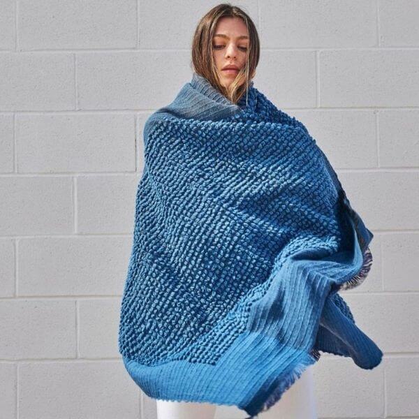 Woman draped in Macaroon Midnight Dark Blue Textured Merino Handloom Throw showcasing its luxurious texture.