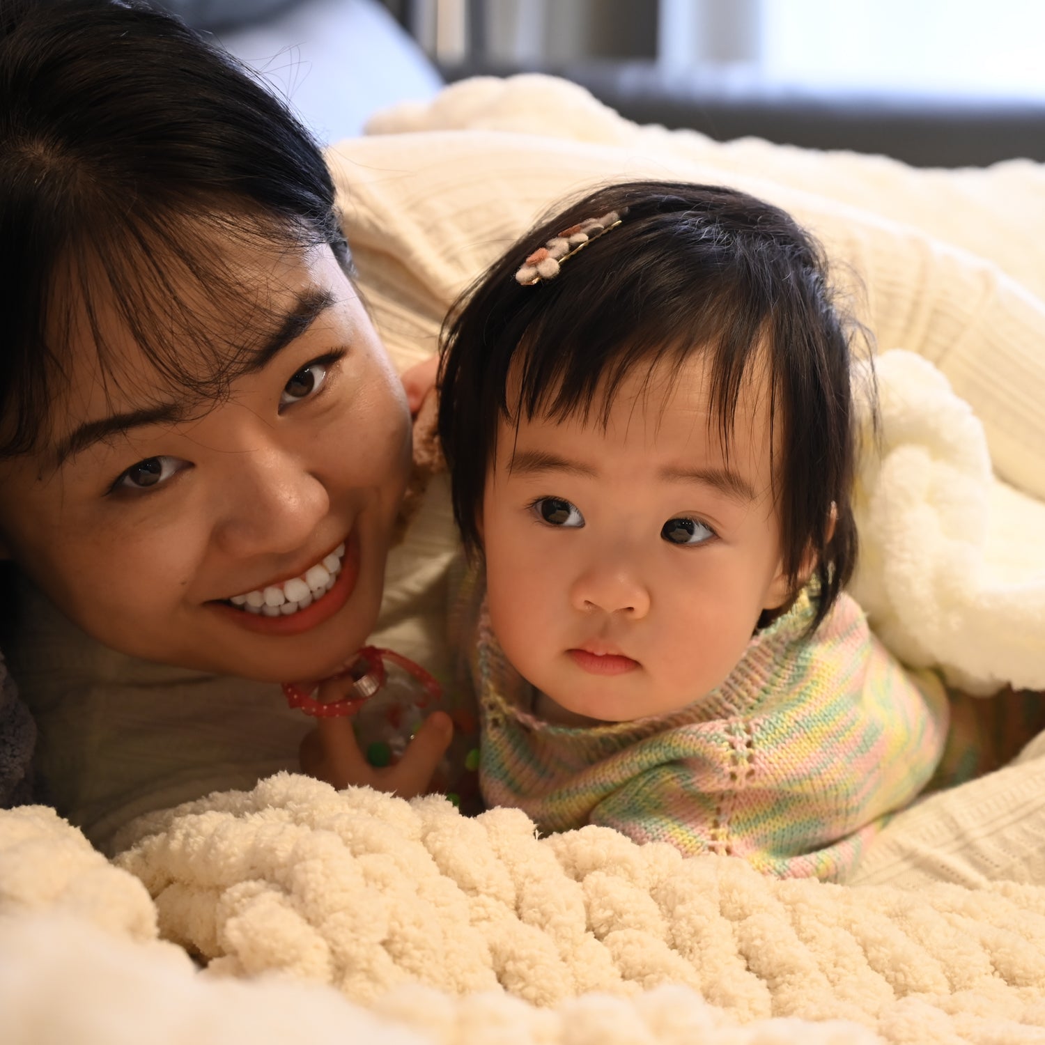 A photo of a mother and daughter in beautifully hand made baby blanket, special mother's day present