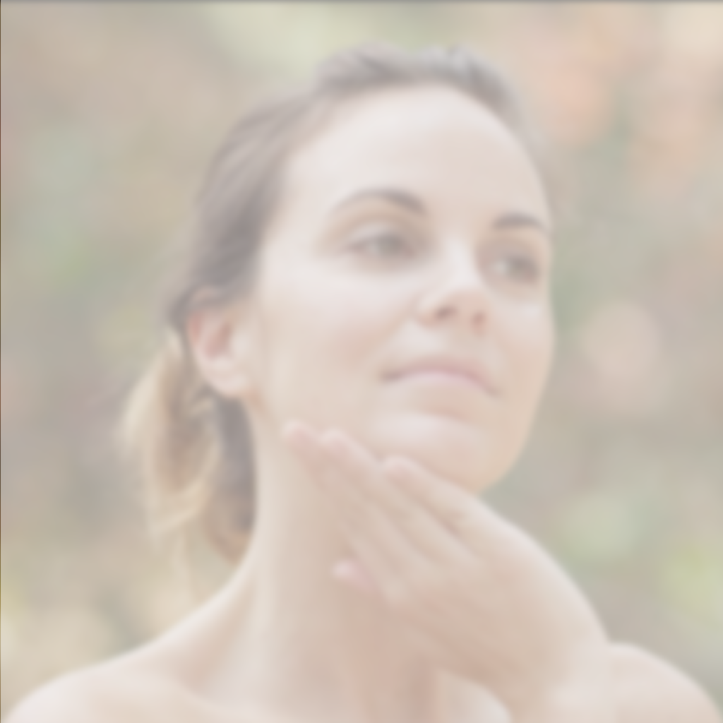 Video of woman gently applying skincare product to her neck and jawline outdoors with soft natural lighting.