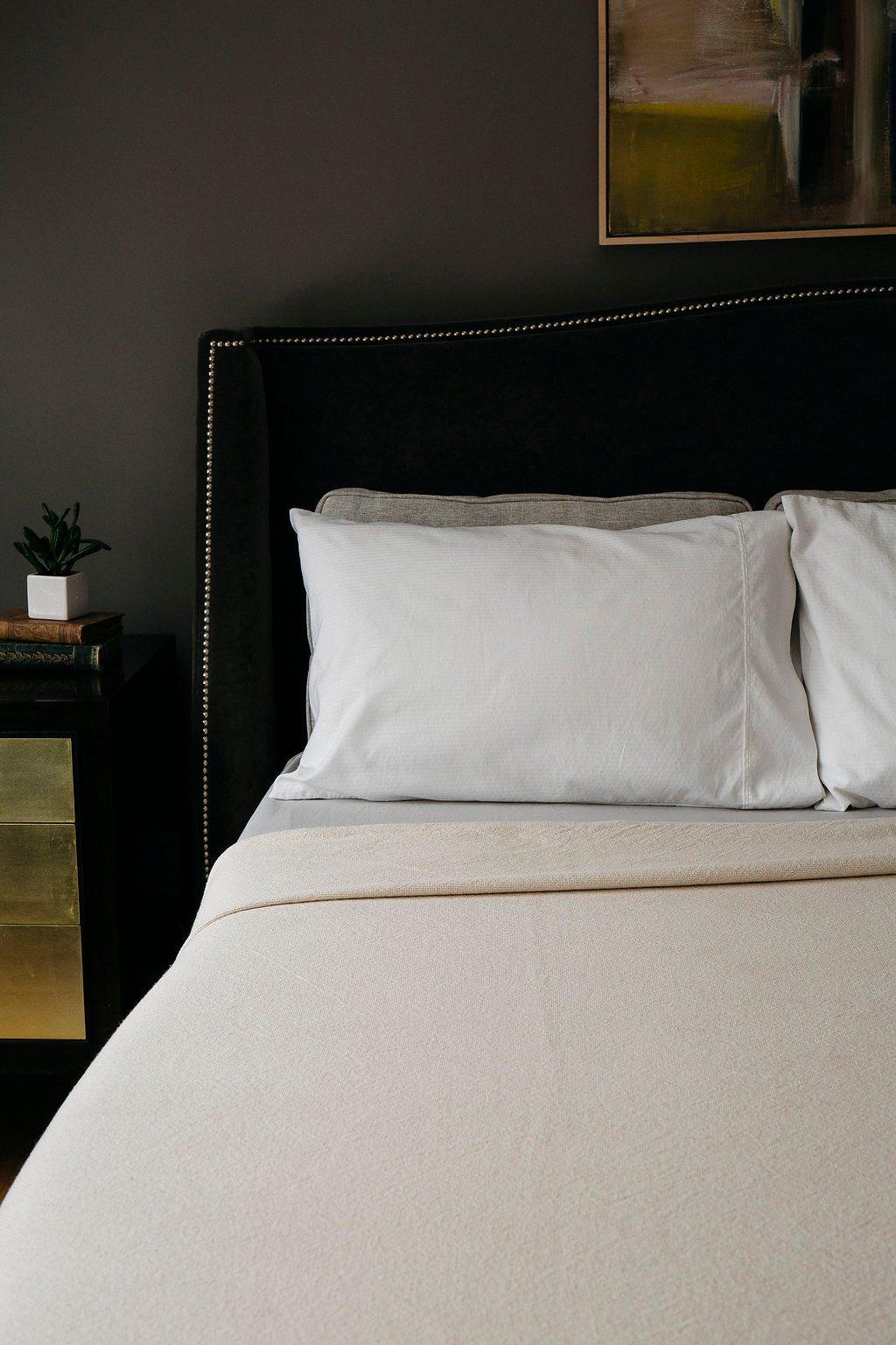 Luxurious bed with white Evangeline linens, 100% Cotton, woven in a plain weave for durability and washability.