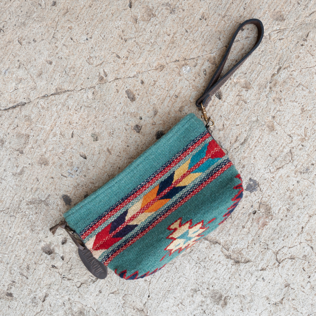 Handwoven convertible clutch with Zapotec pattern in bold colors; can be used as a pouch, wristlet, or crossbody with included leather straps and internal pocket.