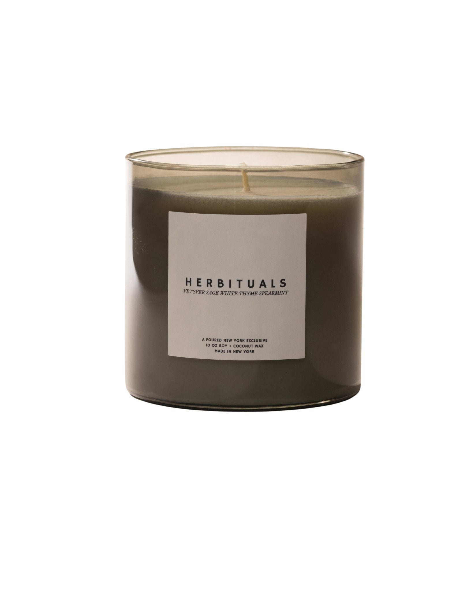 Poured New York 'Herbituals' sage green candle with a matching box on a neutral background