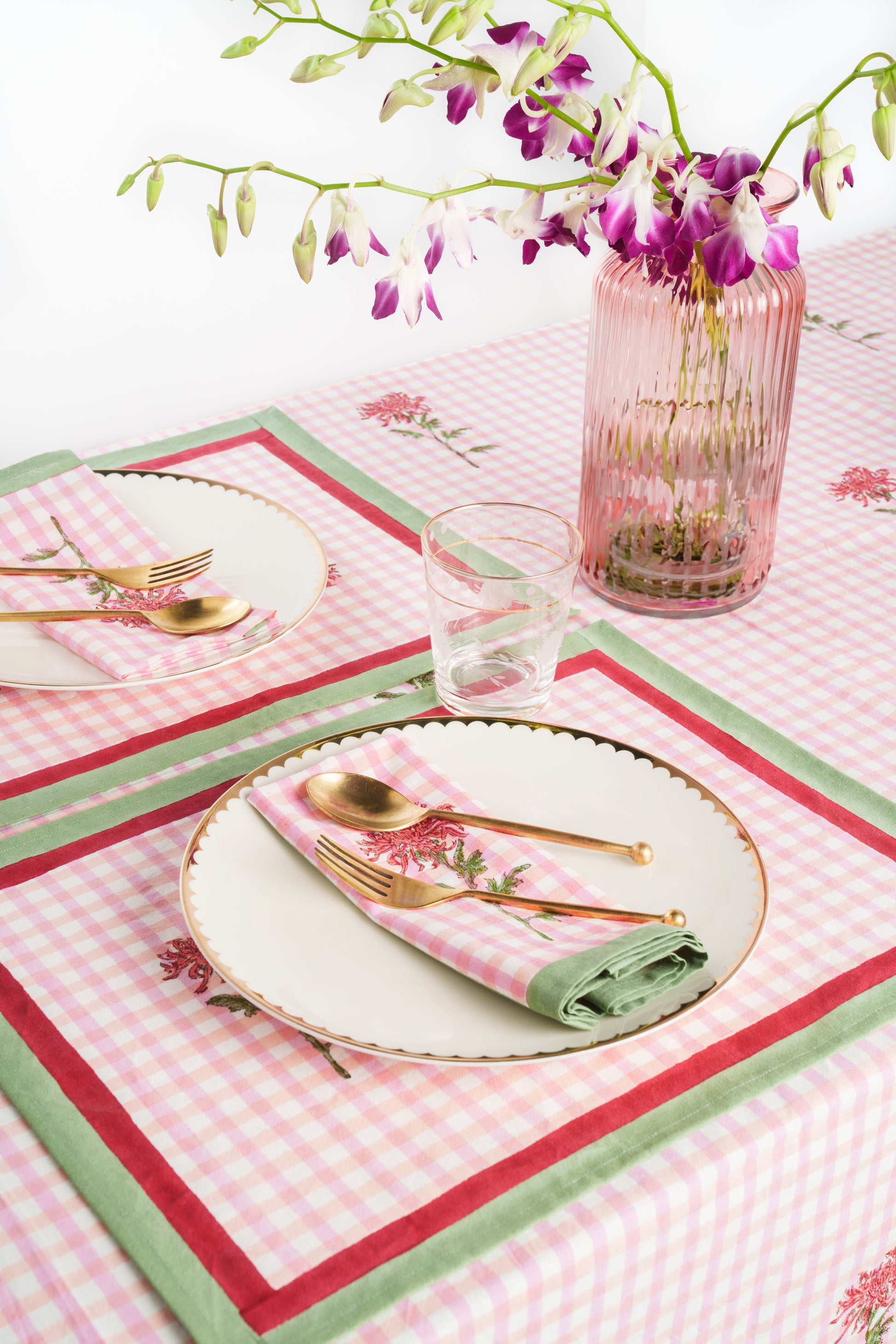Set table with matching pink gingham placemats, gold utensils, orchid vase - Inner Child