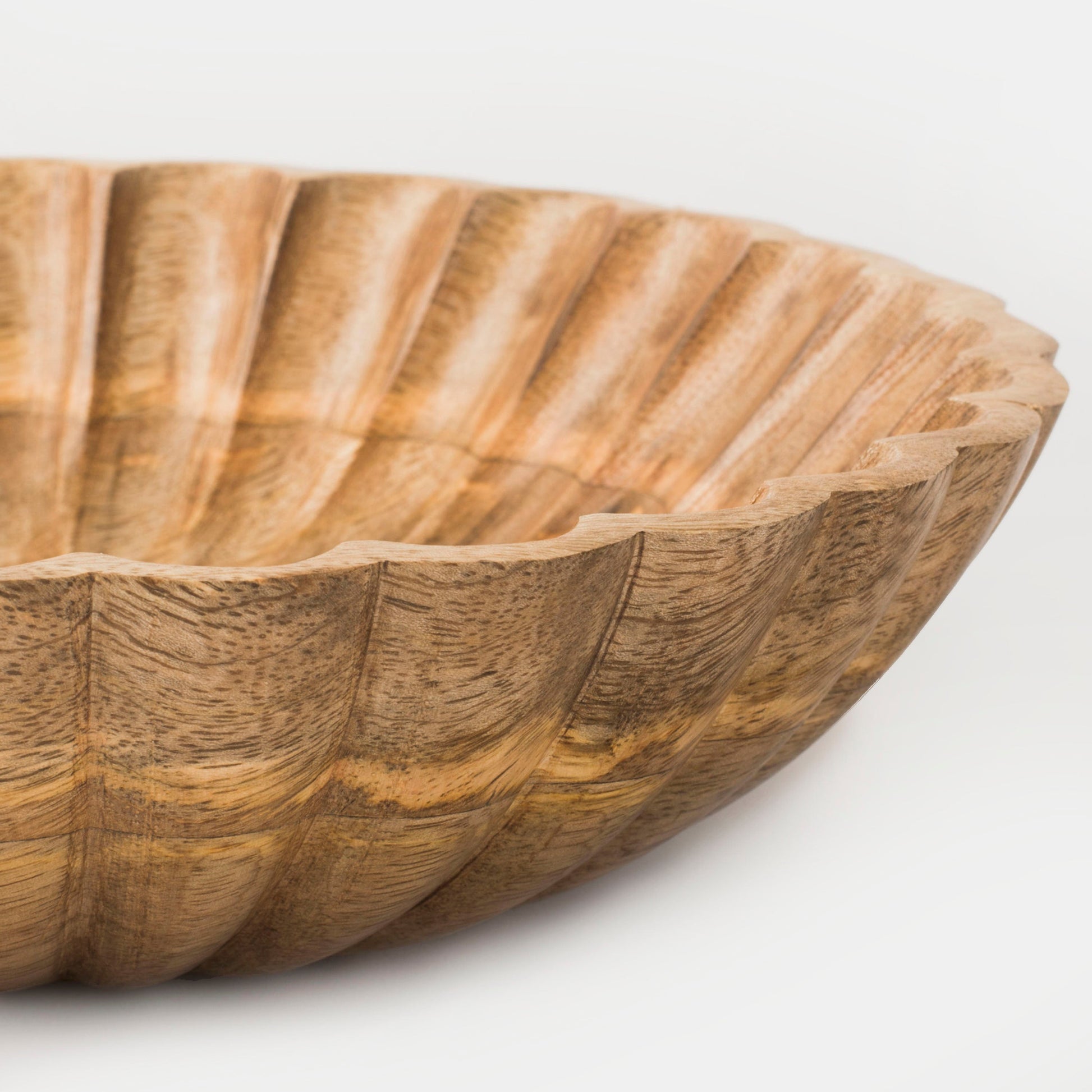 Close-up of carved scalloped pattern and natural wood grain