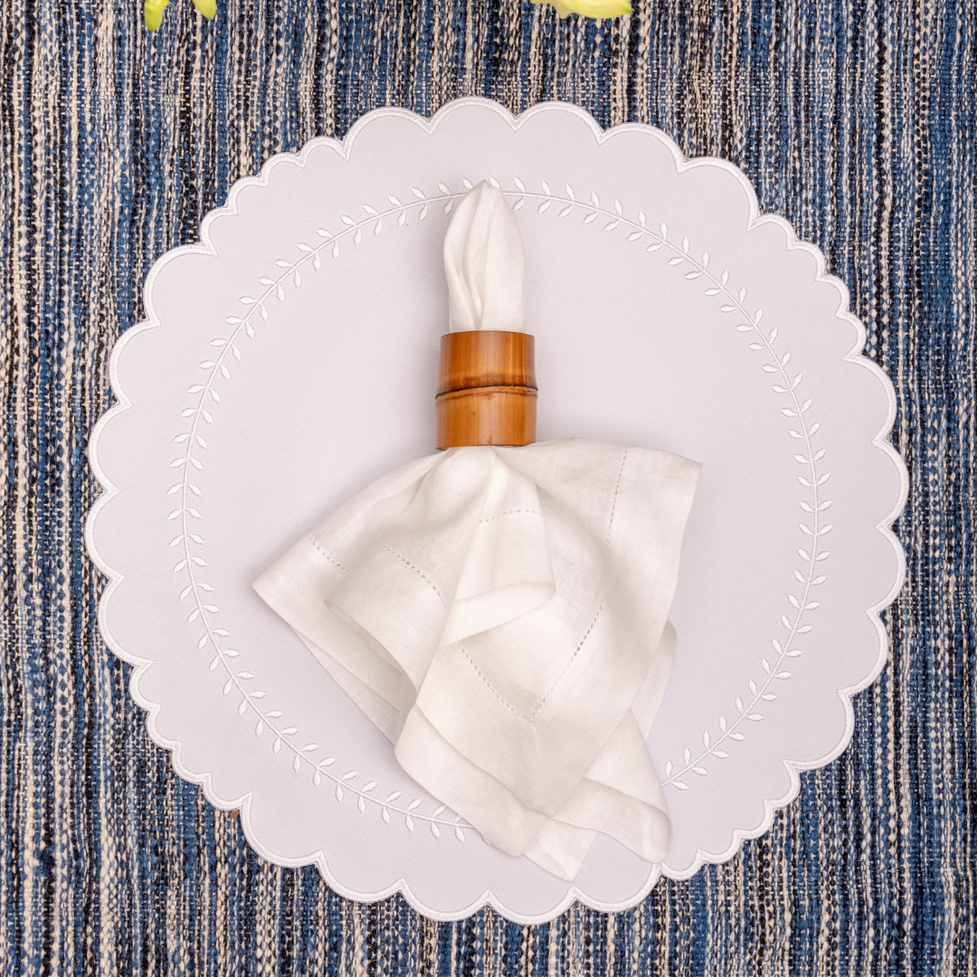 Arrow impermeable placemat with geometric border design in white by Talah Home