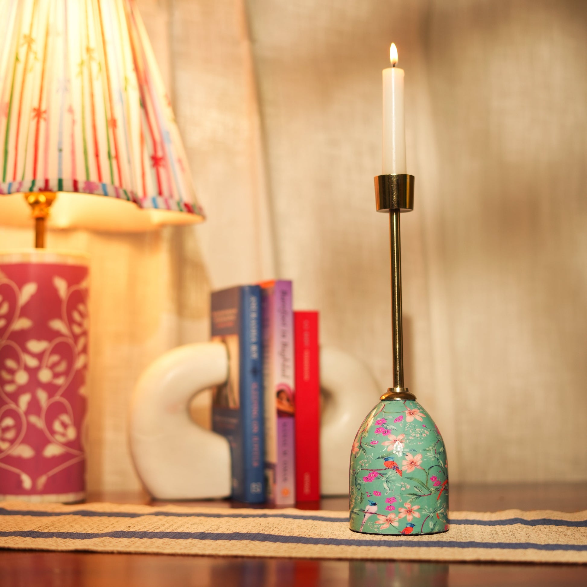 Tall Aqua Flora candleholder featuring a handcrafted enamel floral design and a sleek gold candle cup.
