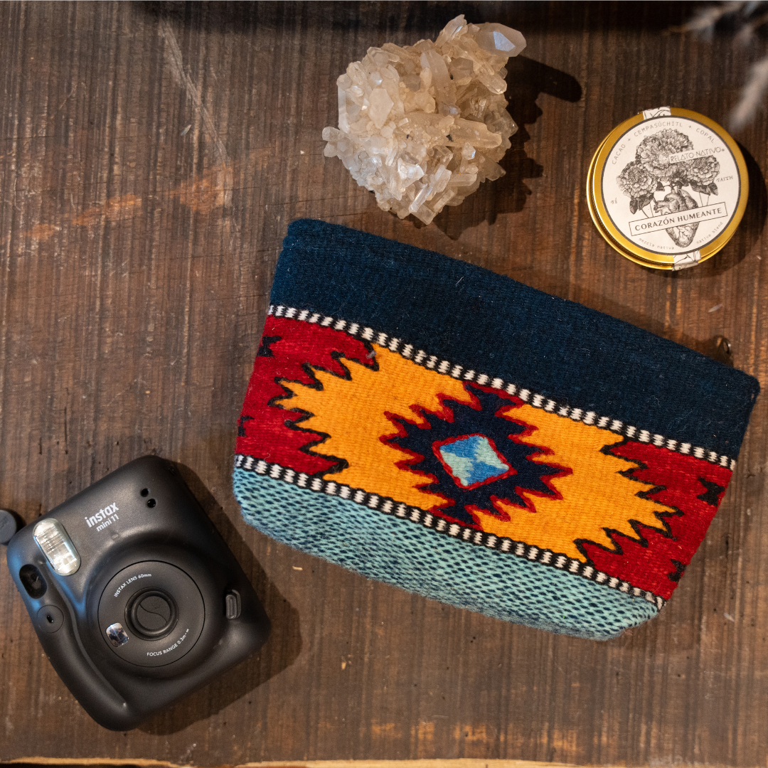 Handwoven convertible clutch with Zapotec pattern in bold colors; can be used as a pouch, wristlet, or crossbody with included leather straps and internal pocket.