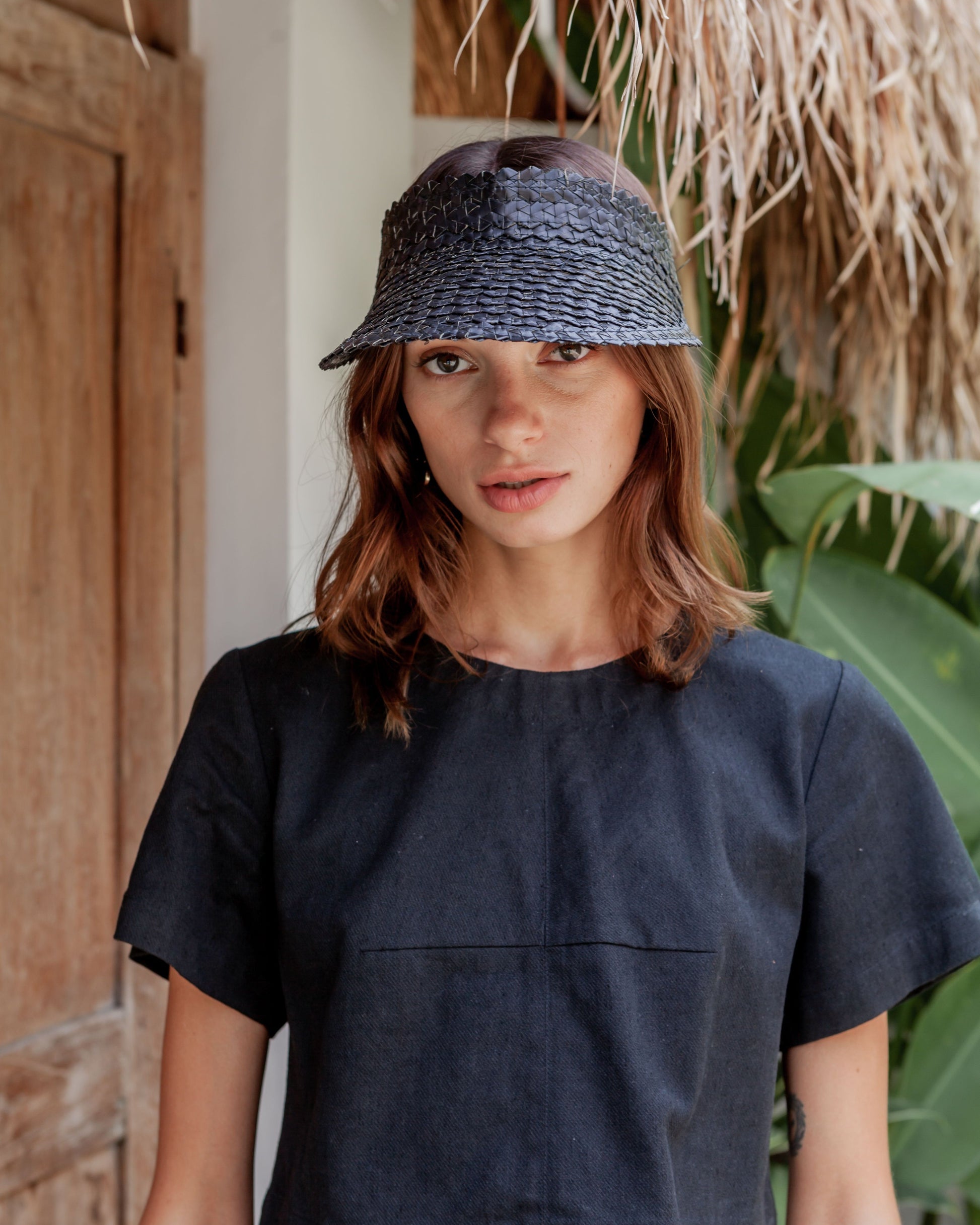 Rattan Sun Visor in Black handmade by Village Thrive using natural materials.