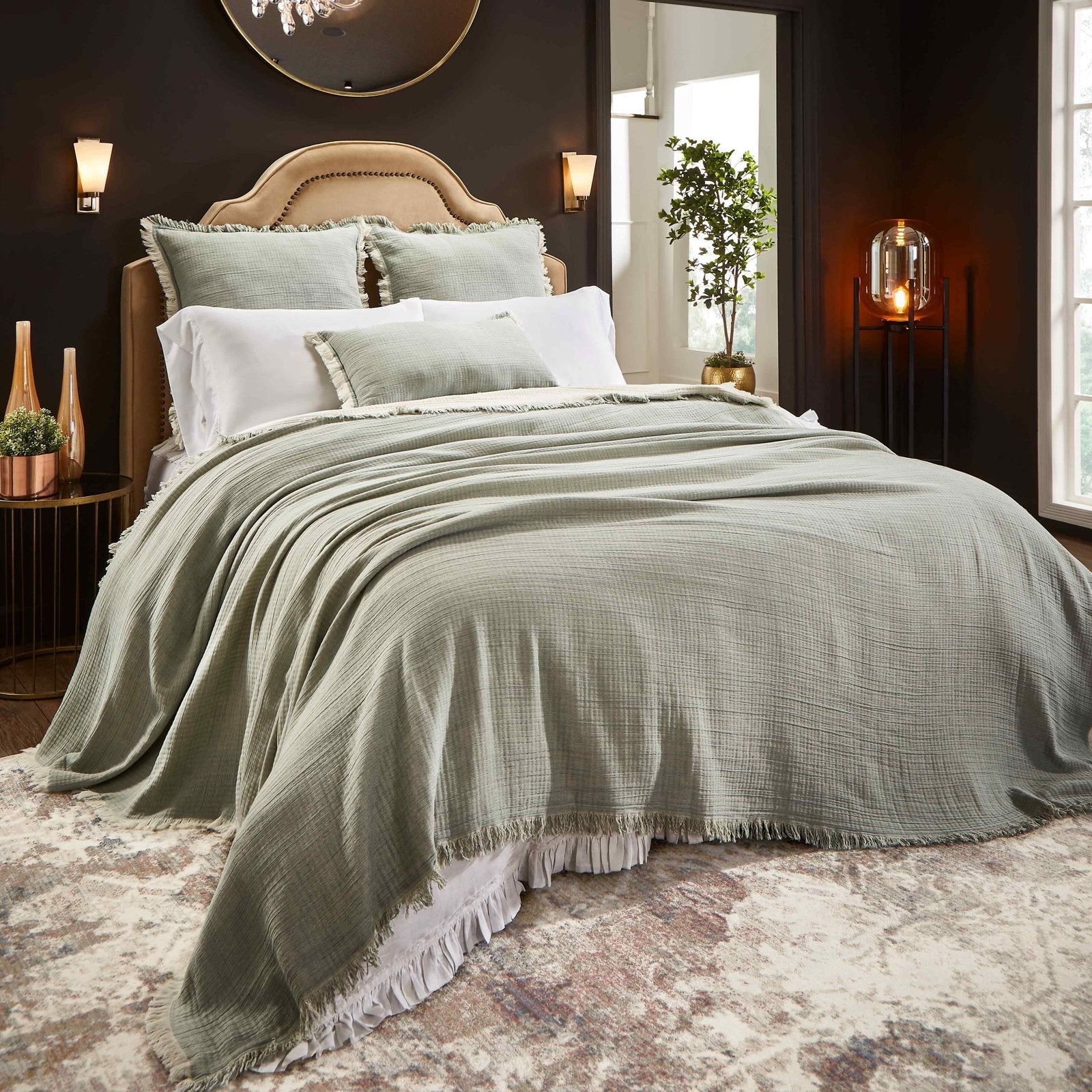 BT-109-11096_1|Stylish sage green crinkled blanket with frayed edges draped over a bed, creating a relaxed, bohemian bedroom aesthetic.