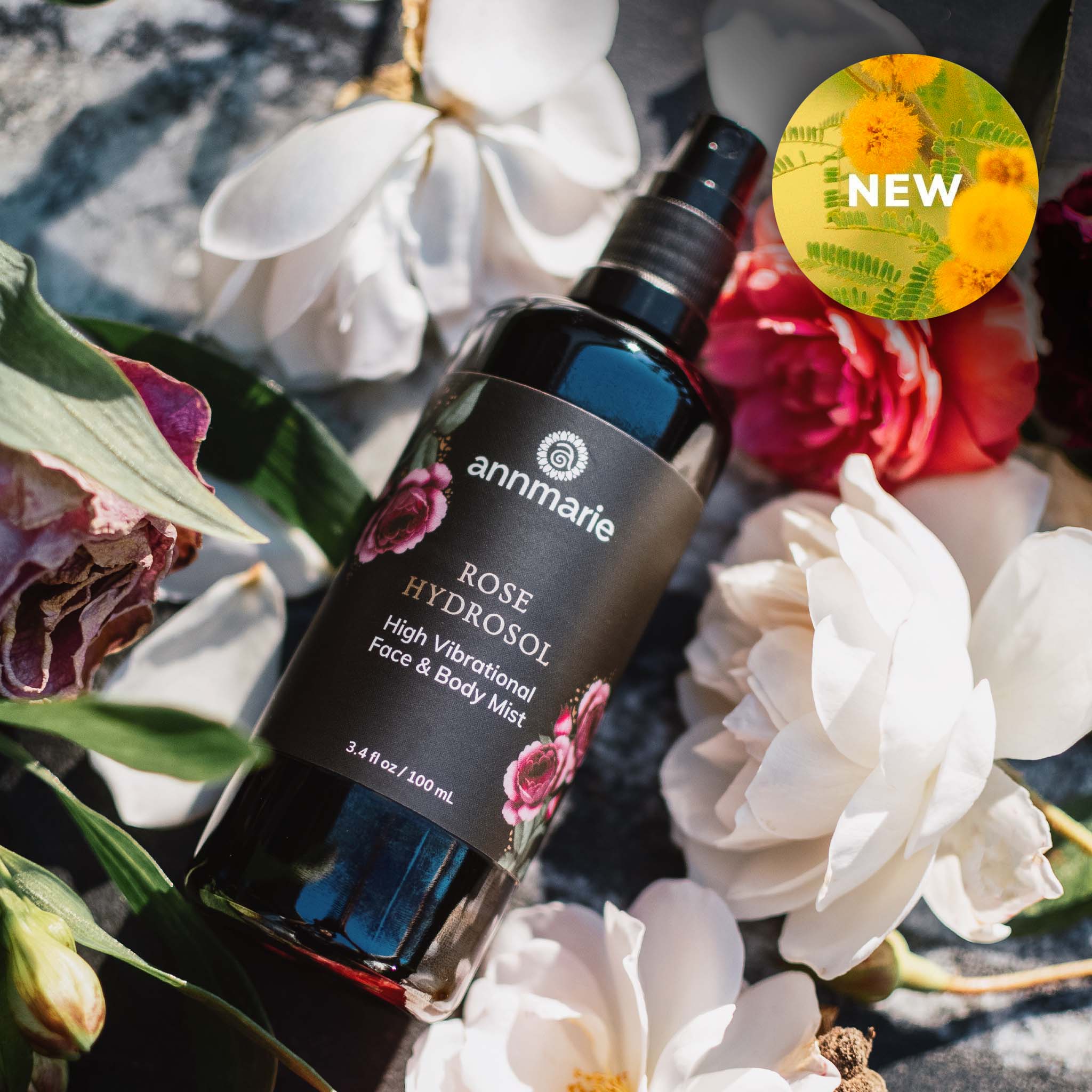 Annmarie Rose Hydrosol bottle surrounded by flowers with a 'NEW' label.