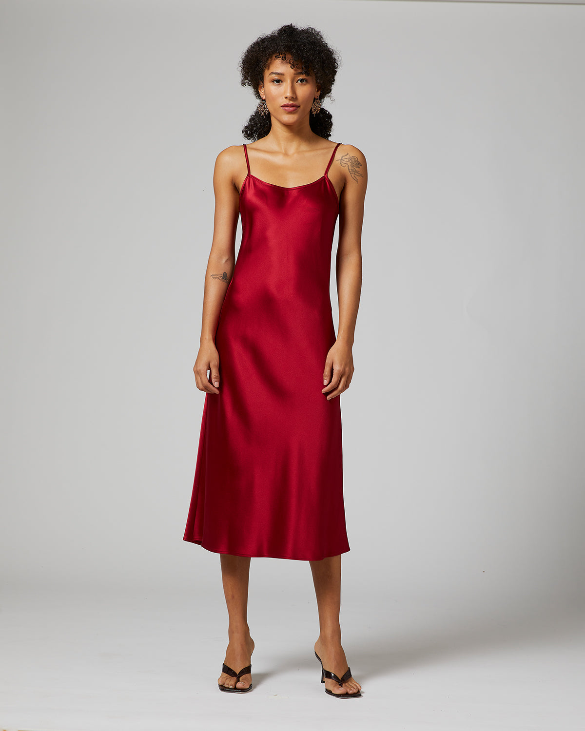 Ruby midi slip dress on a model, showcasing its elegant design.