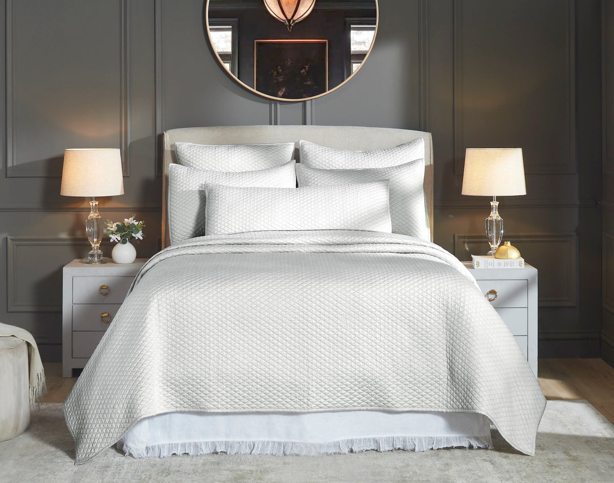 CL-266-9496_1|Elegant white diamond quilted coverlet and pillows adorning a luxurious bed, adding comfort and style to a modern bedroom.