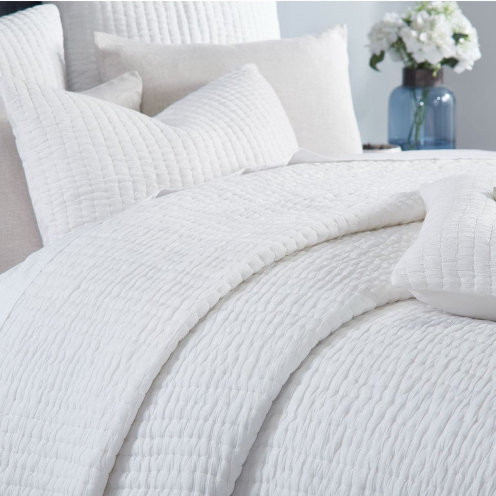QT-359-9496_4|Close-up of a luxurious white textured quilt, highlighting its unique pattern and plush, inviting bedroom comfort.