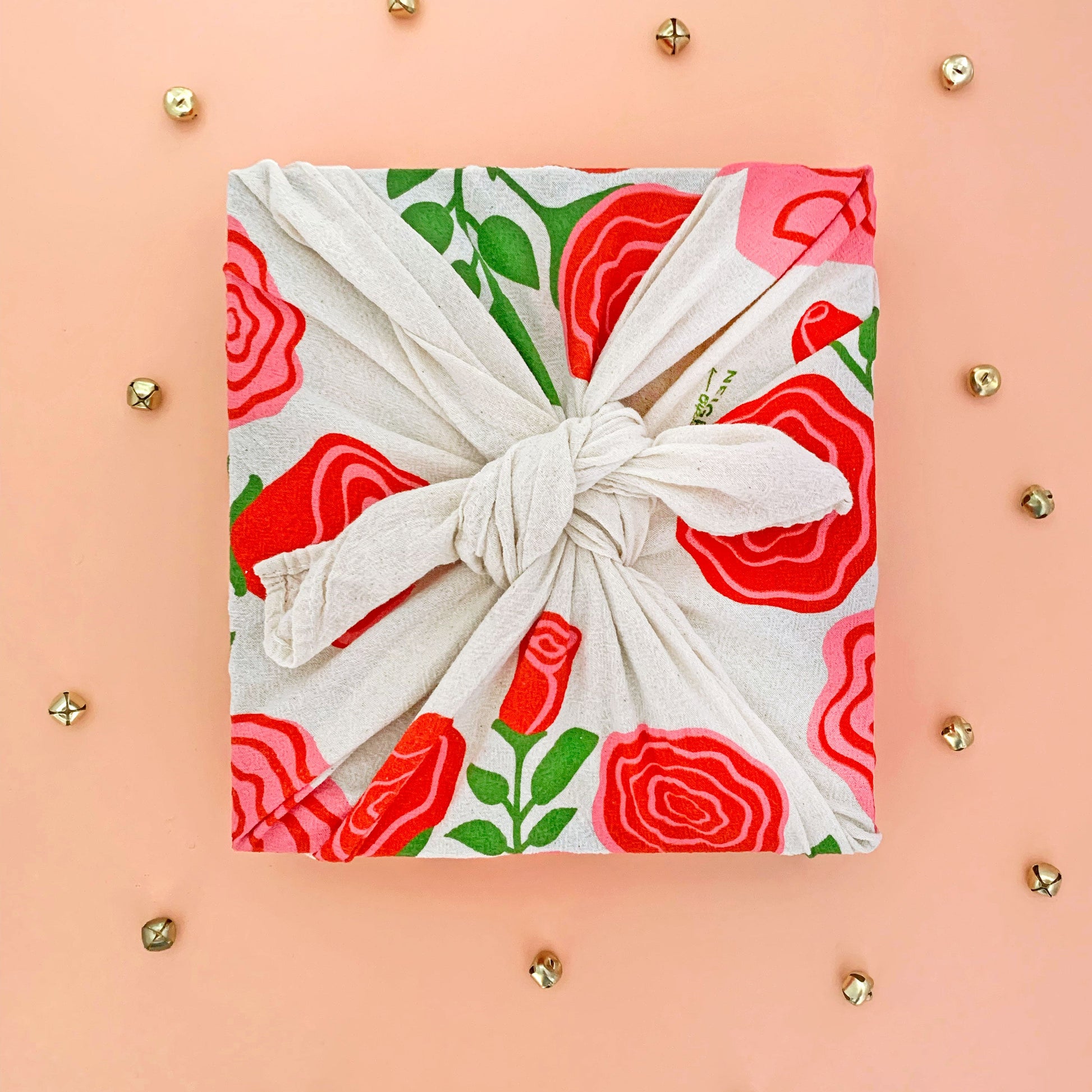 Rose tea towel used as sustainable gift wrap for a holiday present.