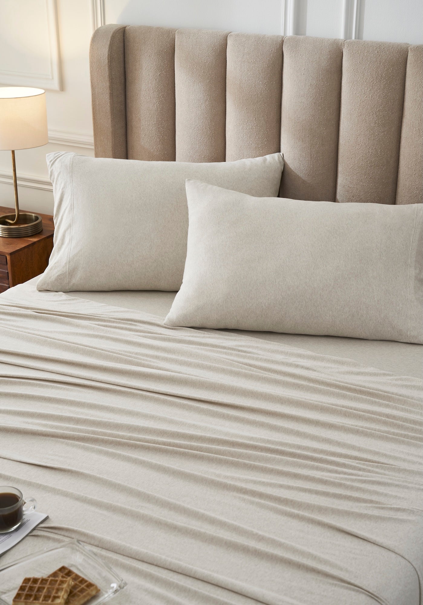 QSS-527-6080_2|Close-up of soft oatmeal 100% cotton sheets and pillowcases on a bed, emphasizing luxurious comfort.