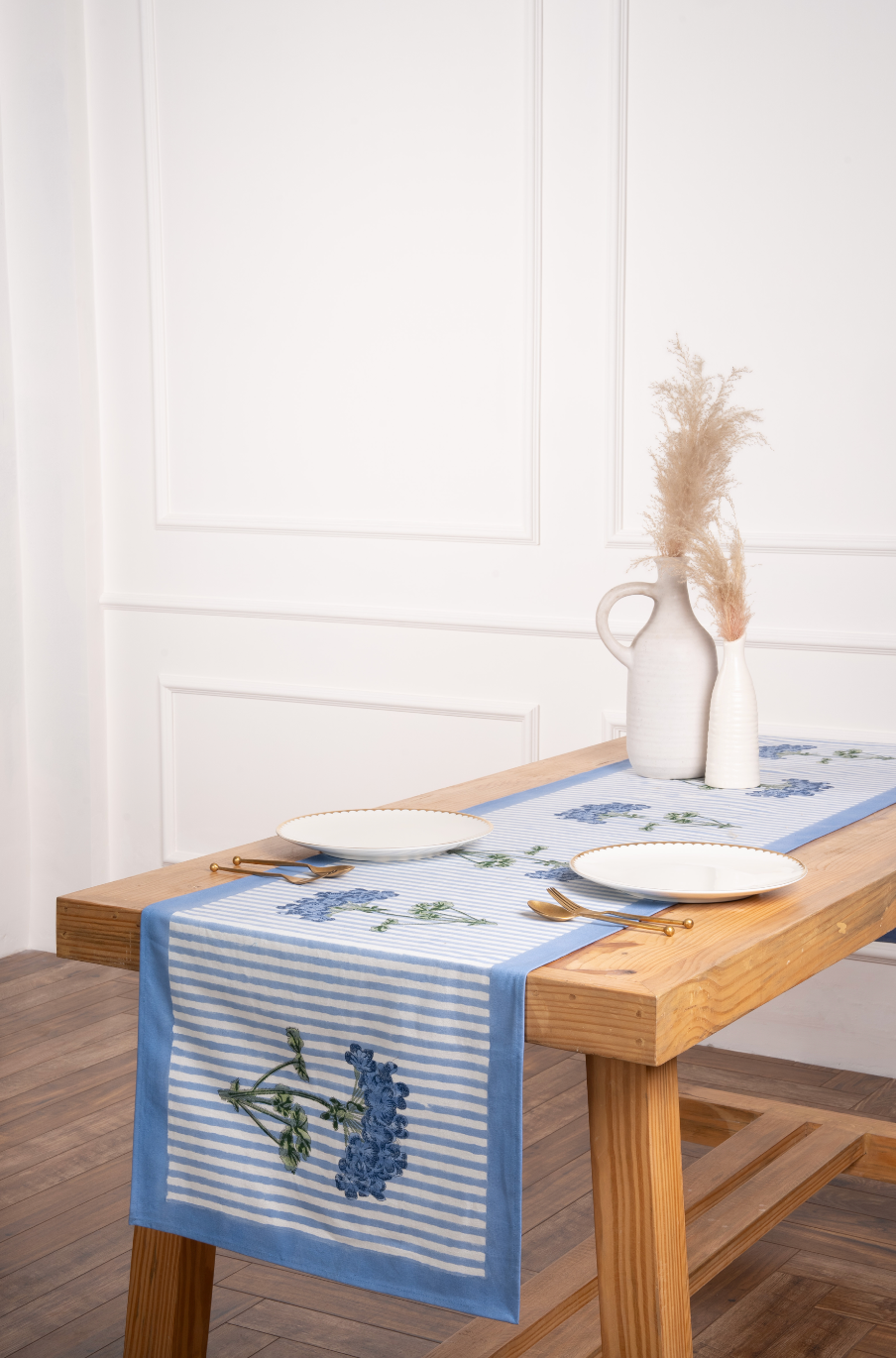 Blue striped tablerunner with hydrangea embroidery on wooden table