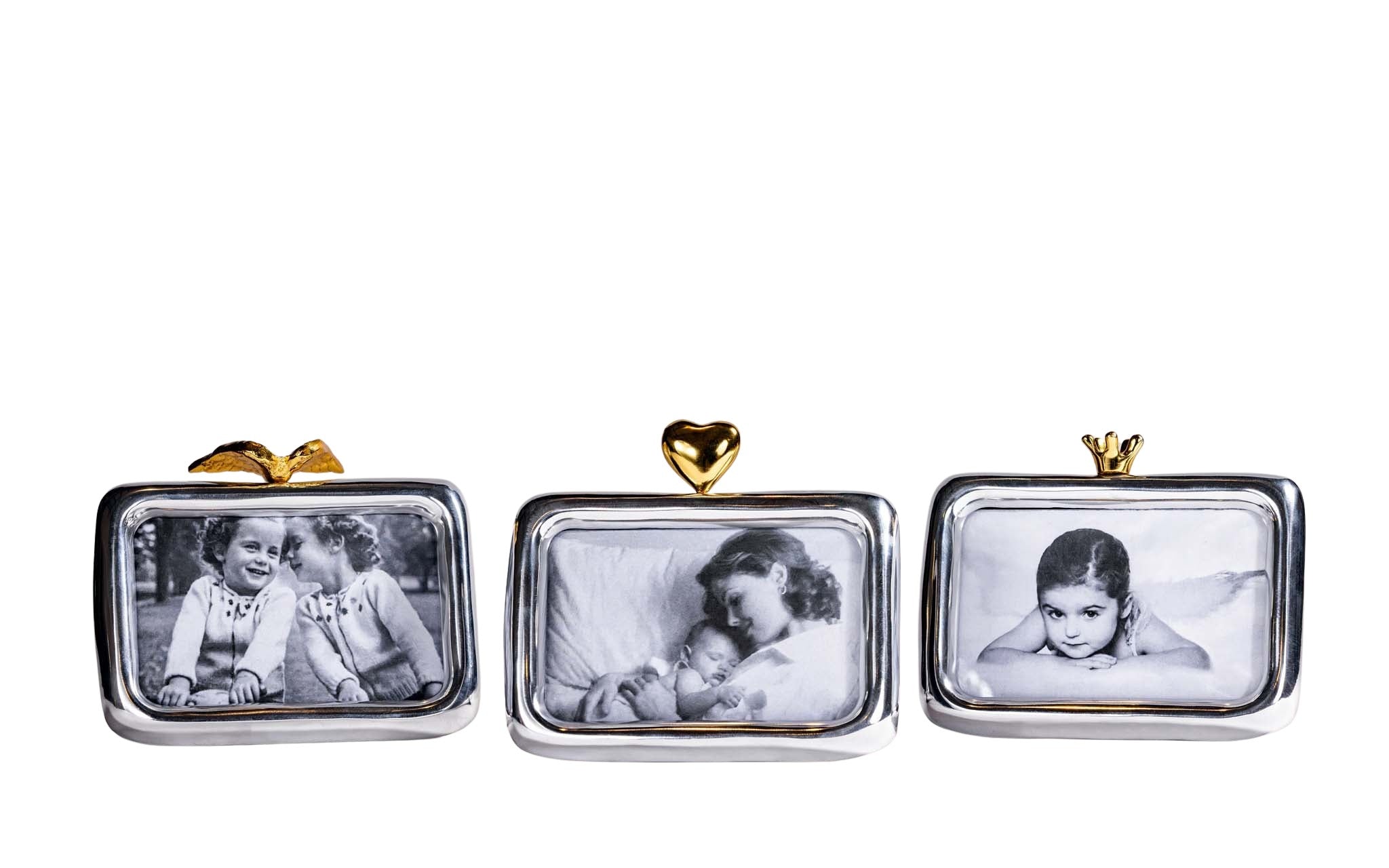 Gold Angelwing figurine on a reflective surface with a black and white photo of two children in the background.