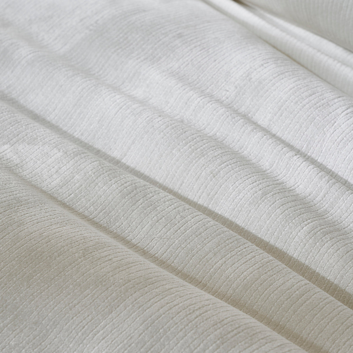 DT-052-9092_6|Extreme close-up of a luxurious white textured duvet cover, showcasing its subtle ribbed fabric and elegant soft folds.
