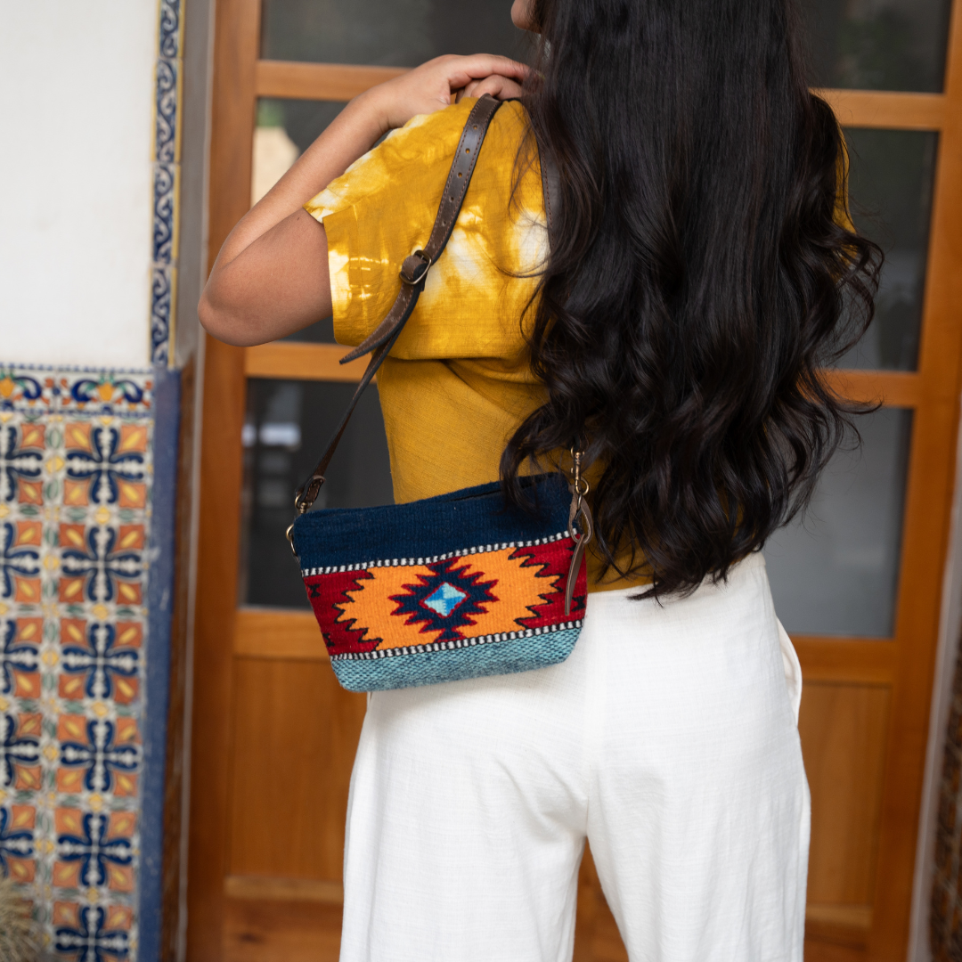 Handwoven convertible clutch with Zapotec pattern in bold colors; can be used as a pouch, wristlet, or crossbody with included leather straps and internal pocket.