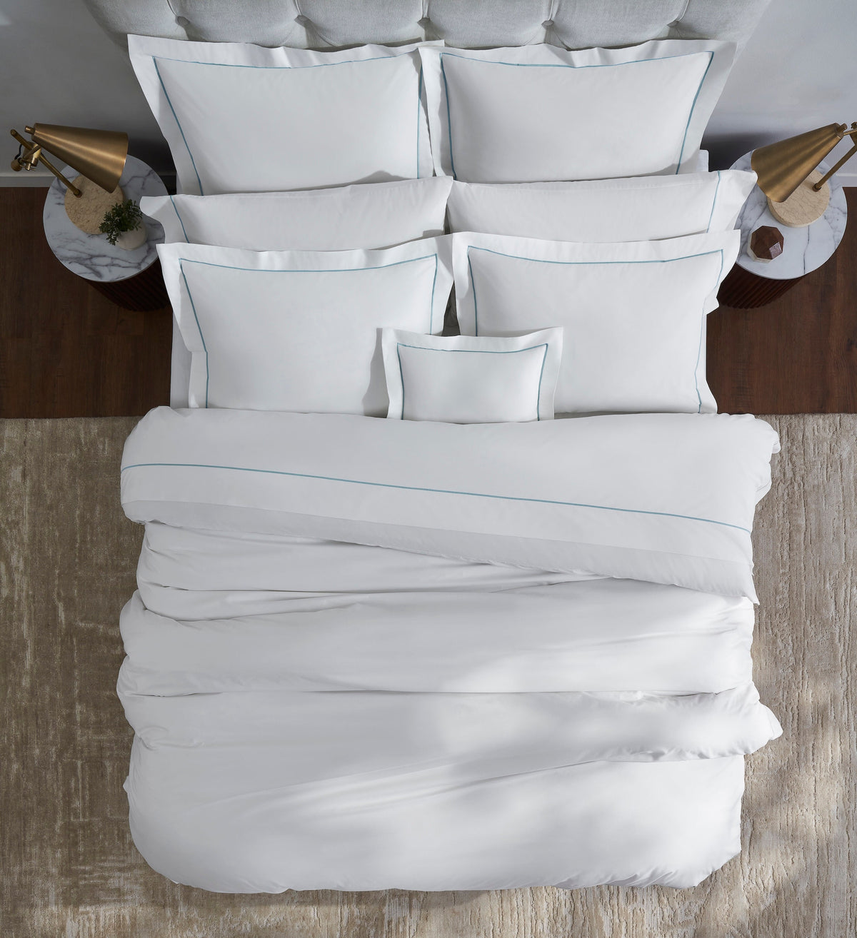 DT-055-10692_3|Crisp white duvet cover with elegant blue trim, neatly arranged on a bed, providing a top-down view of luxurious bedding.