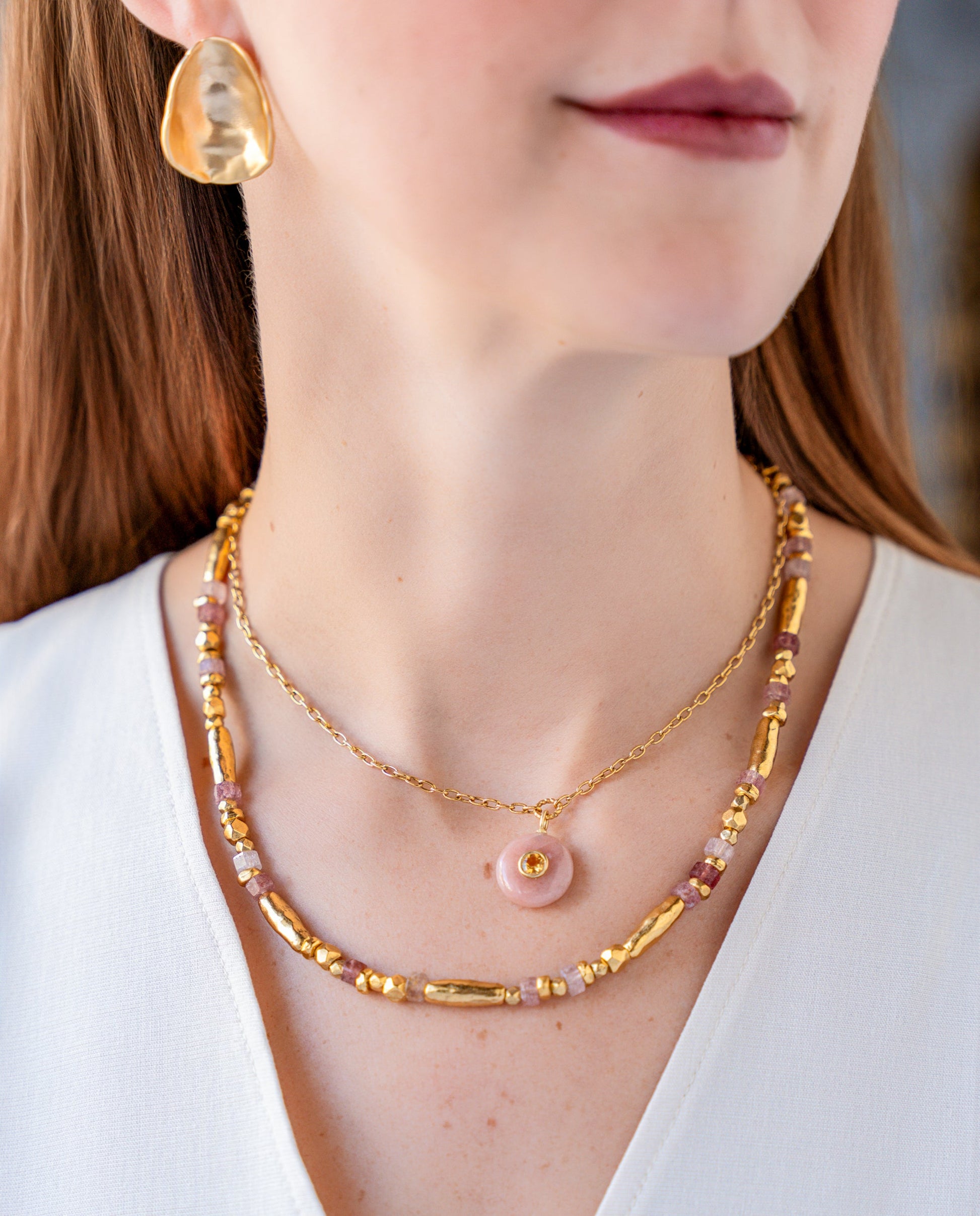 Necklace with pink strawberry quartz beads and organic gold-tone beads in an alternating organic pattern.
