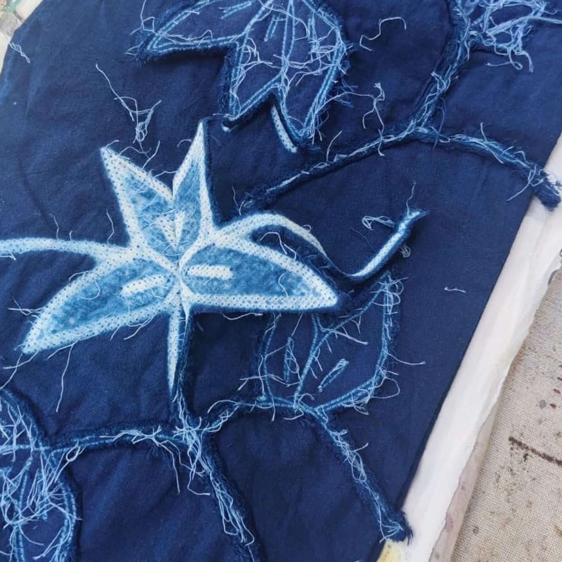 Folio Indigo Handcrafted Shibori Cotton Table Napkins ( set of 4 ) showcasing intricate blue shibori patterns on cotton.