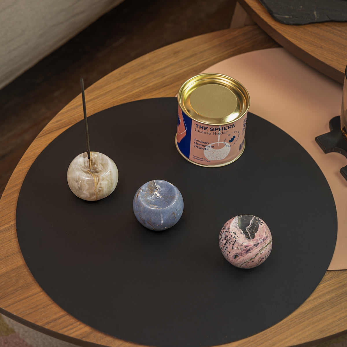 Detail of the Celestina gemstone sphere incense holder displayed alongside other decorative pieces from the natural stone collection.