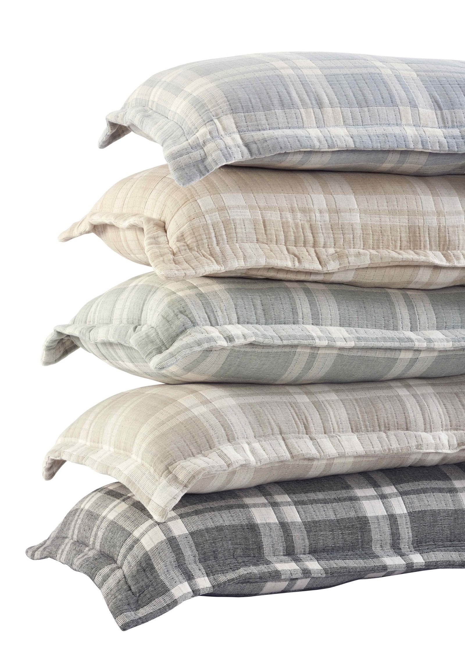 TP-118-1640_3|Angled view of a stack of cozy plaid pillows in various neutral tones and patterns. Comfortable and stylish home bedding.