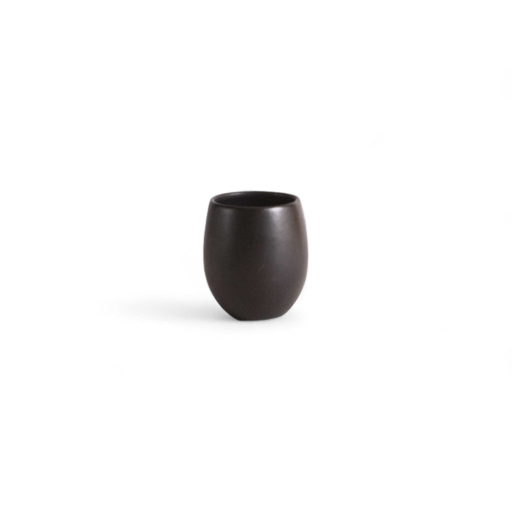 Single stoneware espresso tumbler in a matte black color displayed against a white background