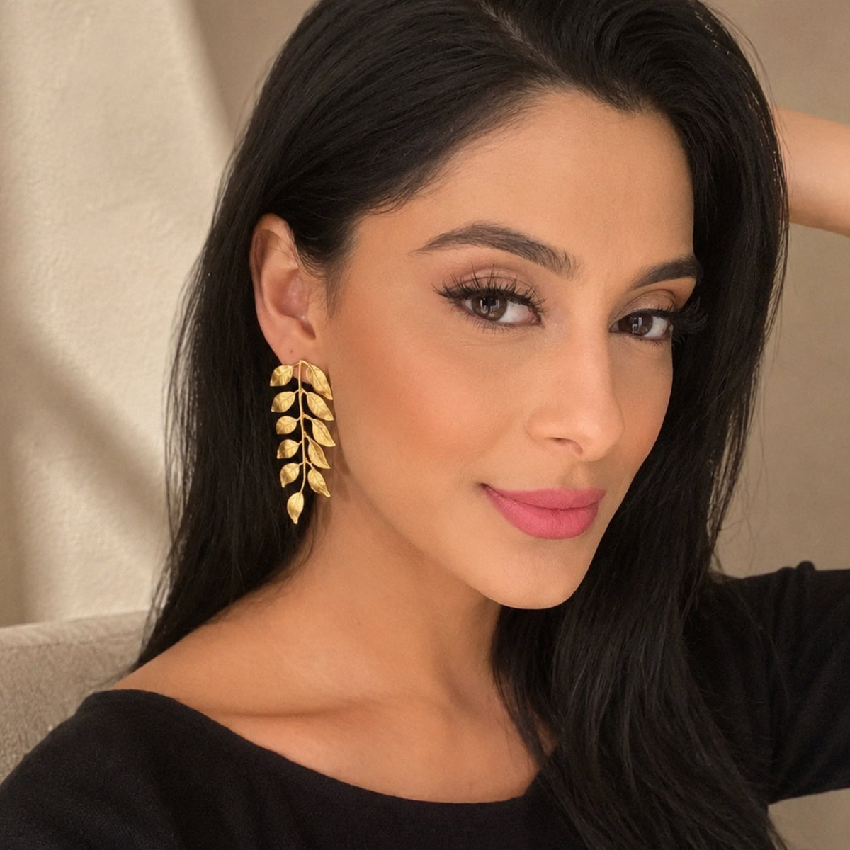 Manpreet Toor wearing gold plated vine earrings by Bebek Jewels with neutral background