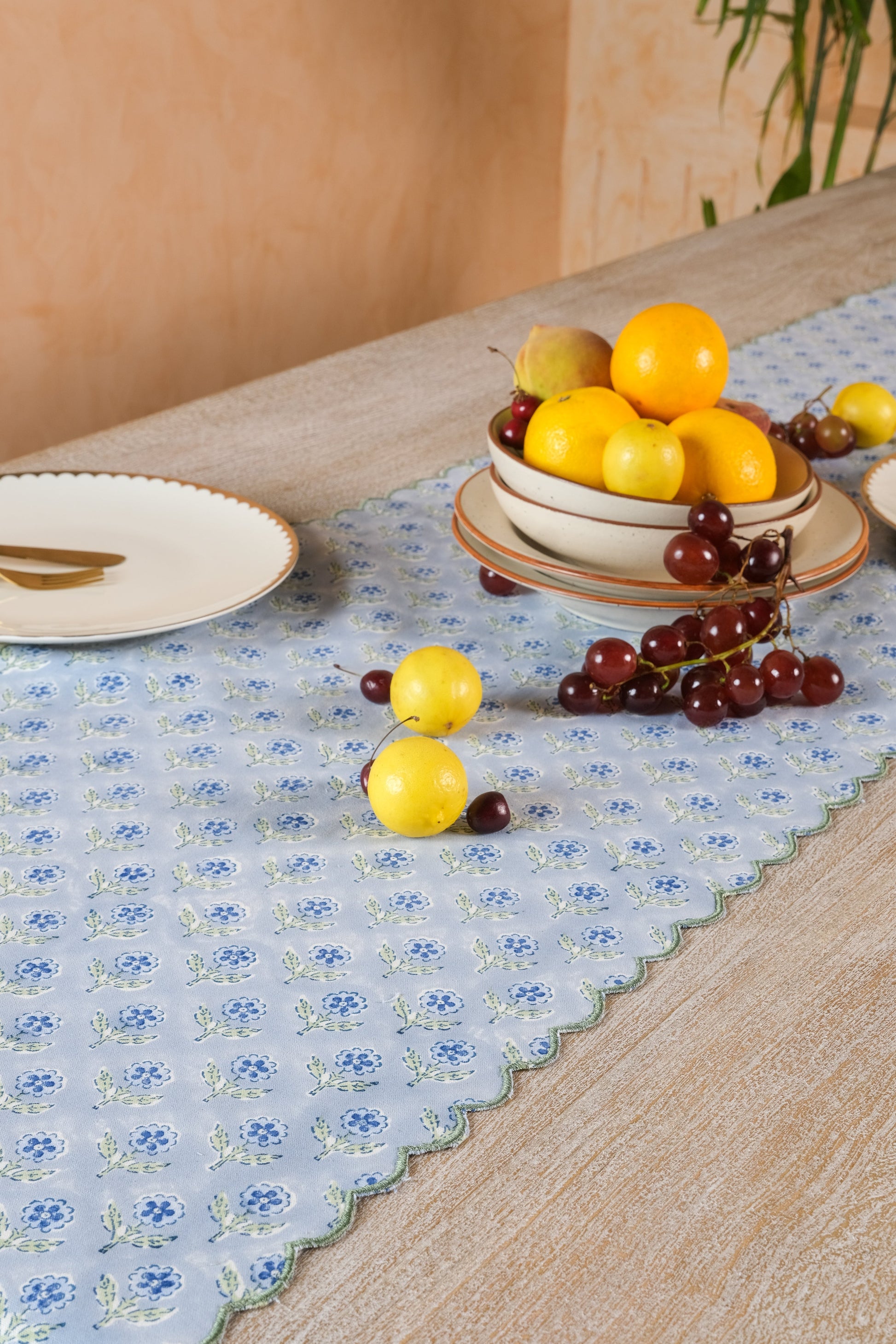 Inner Child blue scallop-edged embroidered blockprint tablerunner on wooden table