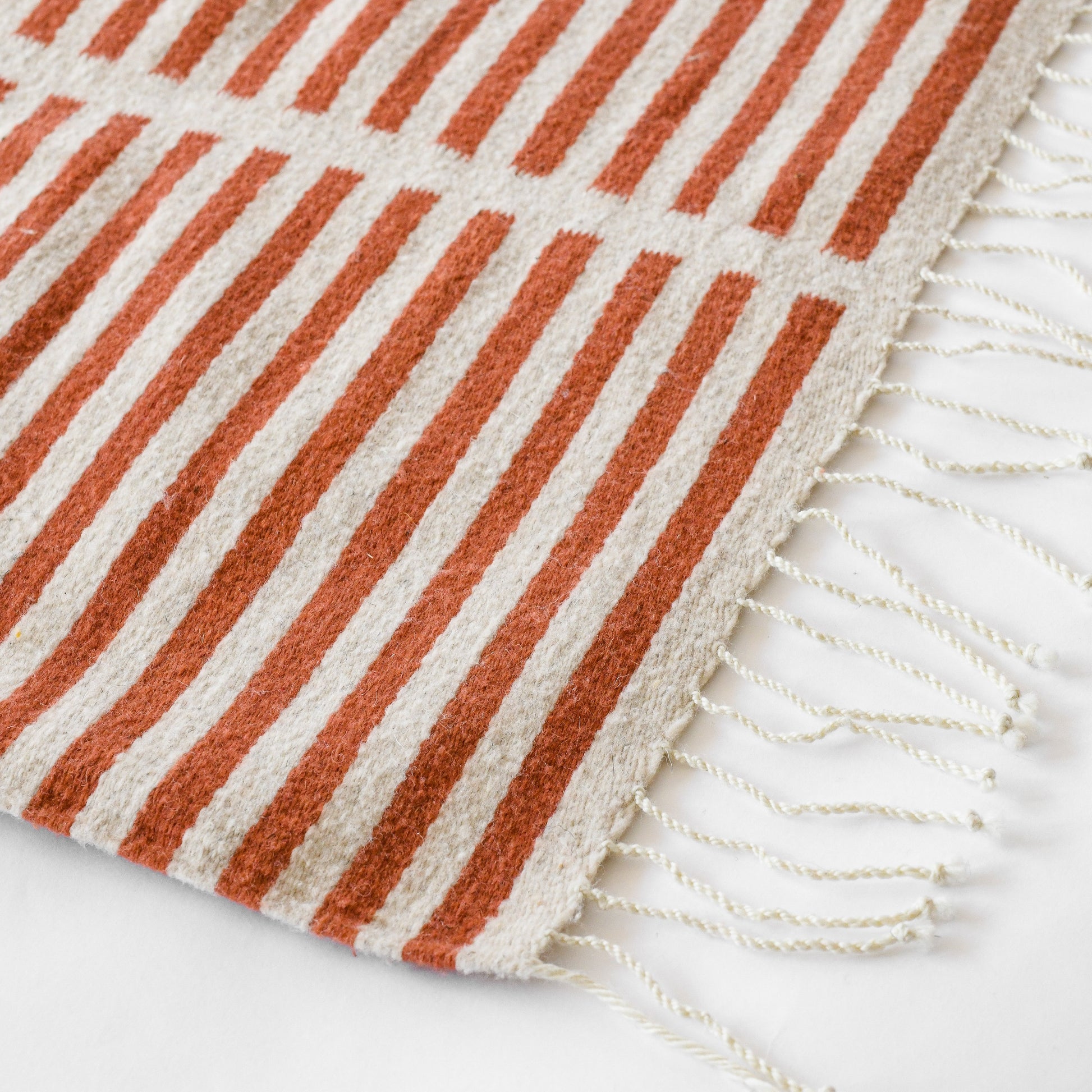 LOOM Imports handwoven ethical flat weave wool rugs. B Corp certified, women owned, fair trade, natural sustainable materials. 