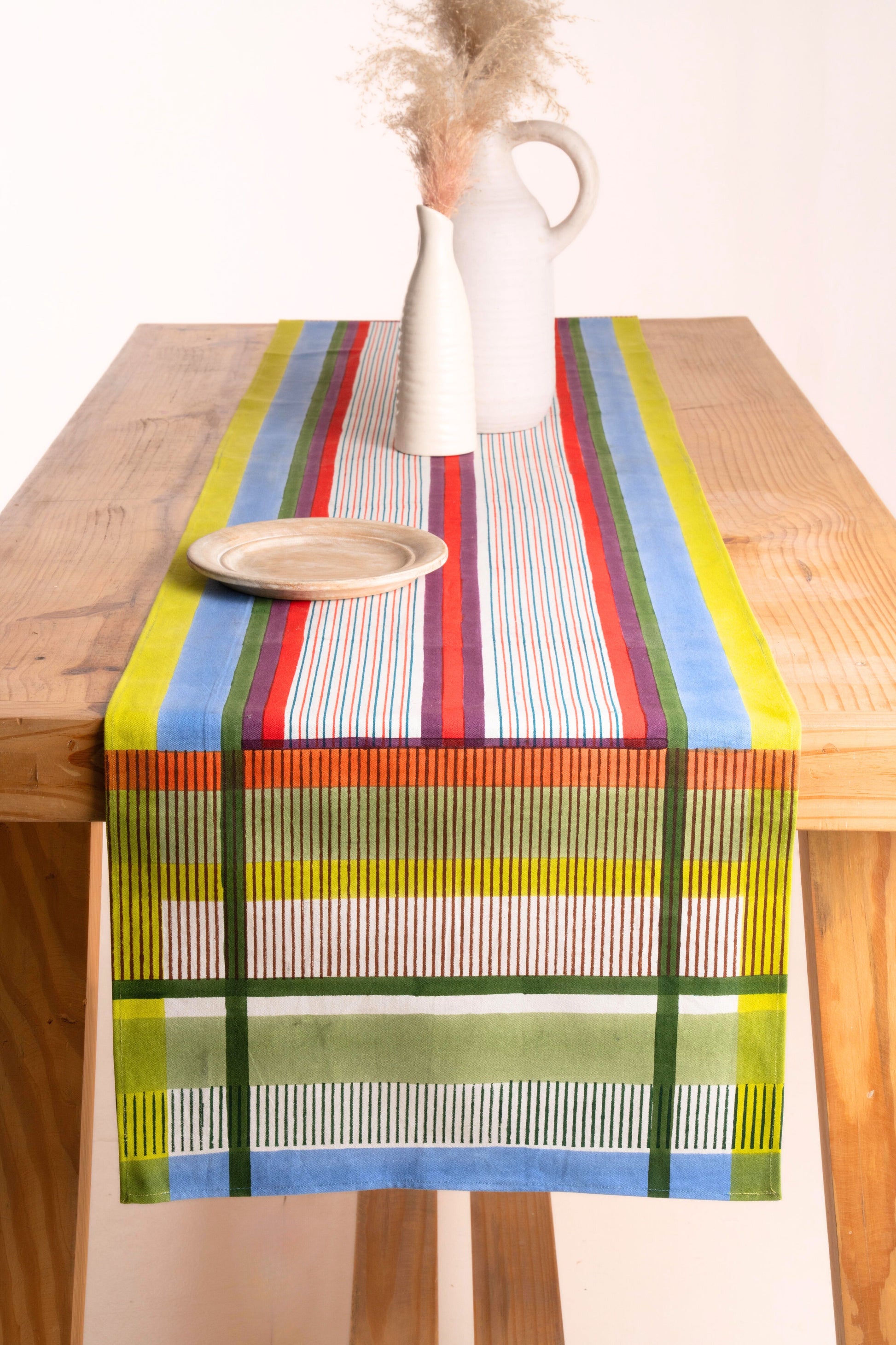 Colorful striped modernist table runner on wooden table