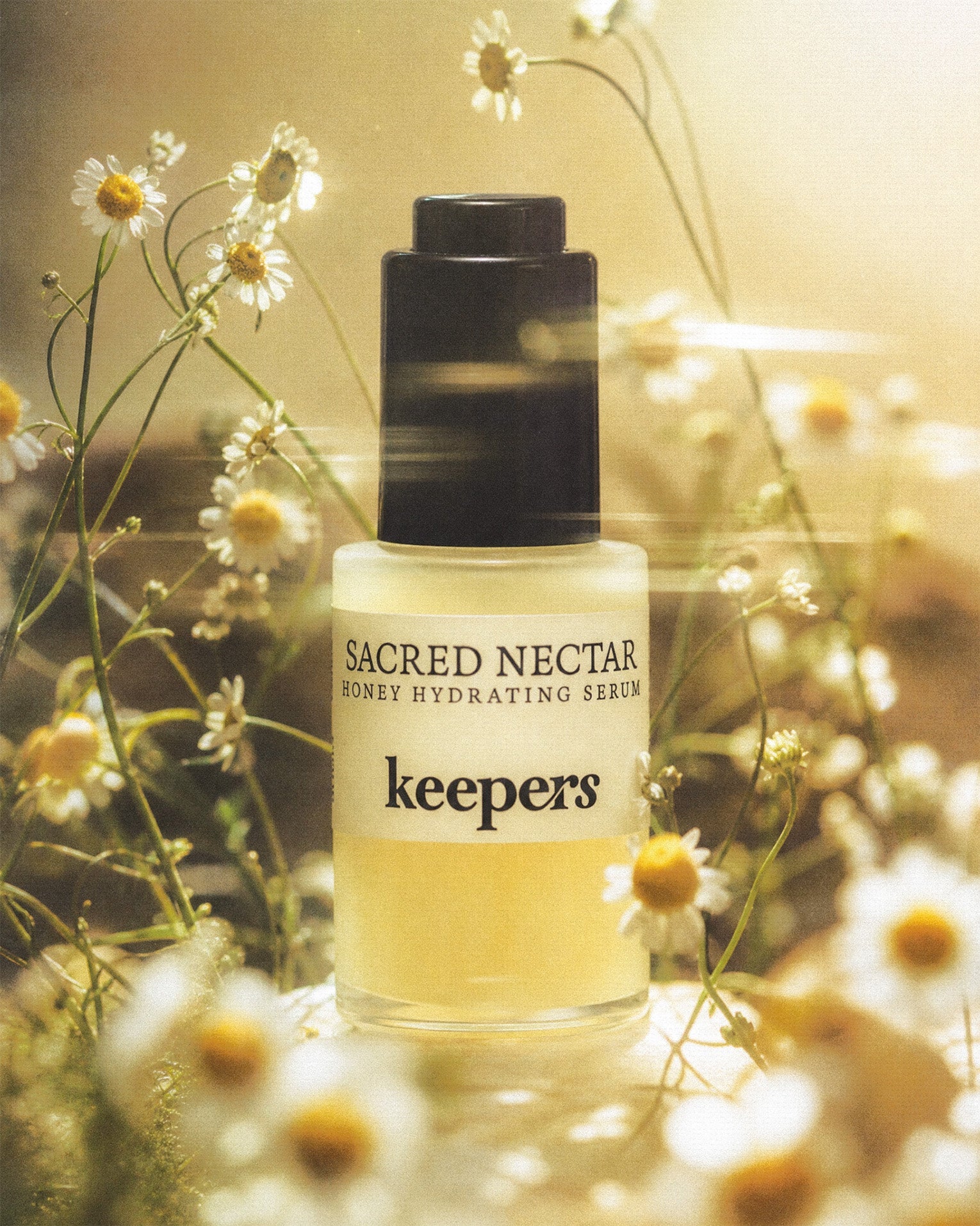 Sacred Nectar hydrating serum bottle with flowers