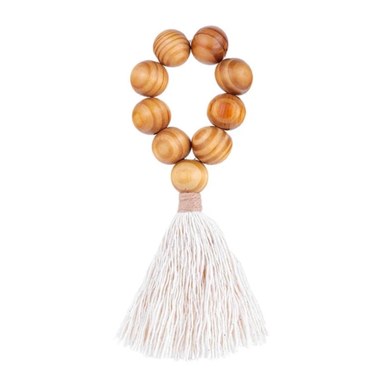 Boho napkin ring with natural wooden beads and cotton tassel handcrafted in Brazil by Talah Home