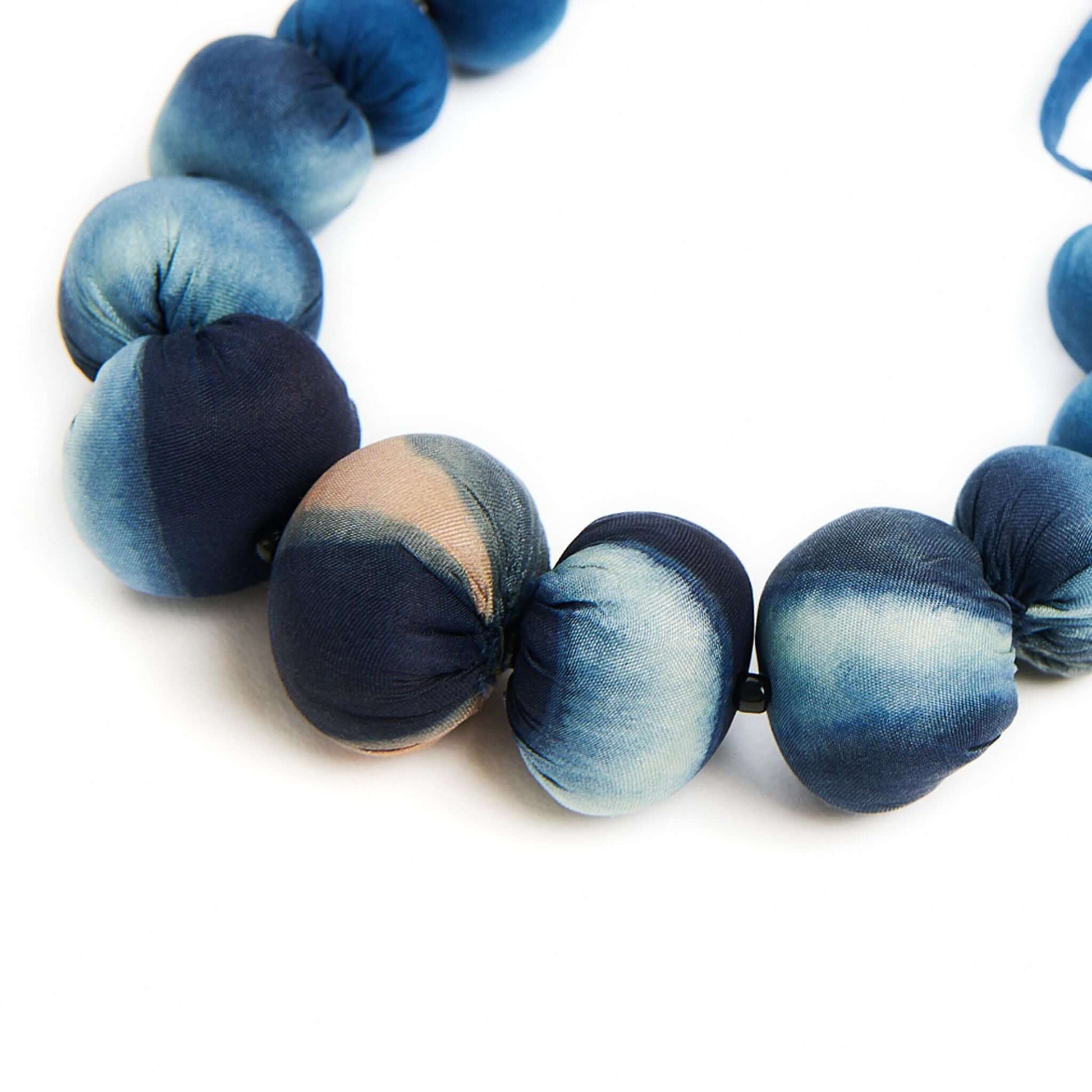 Mihika silk beaded necklace featuring handcrafted silk beads in shades of blue and natural variations.